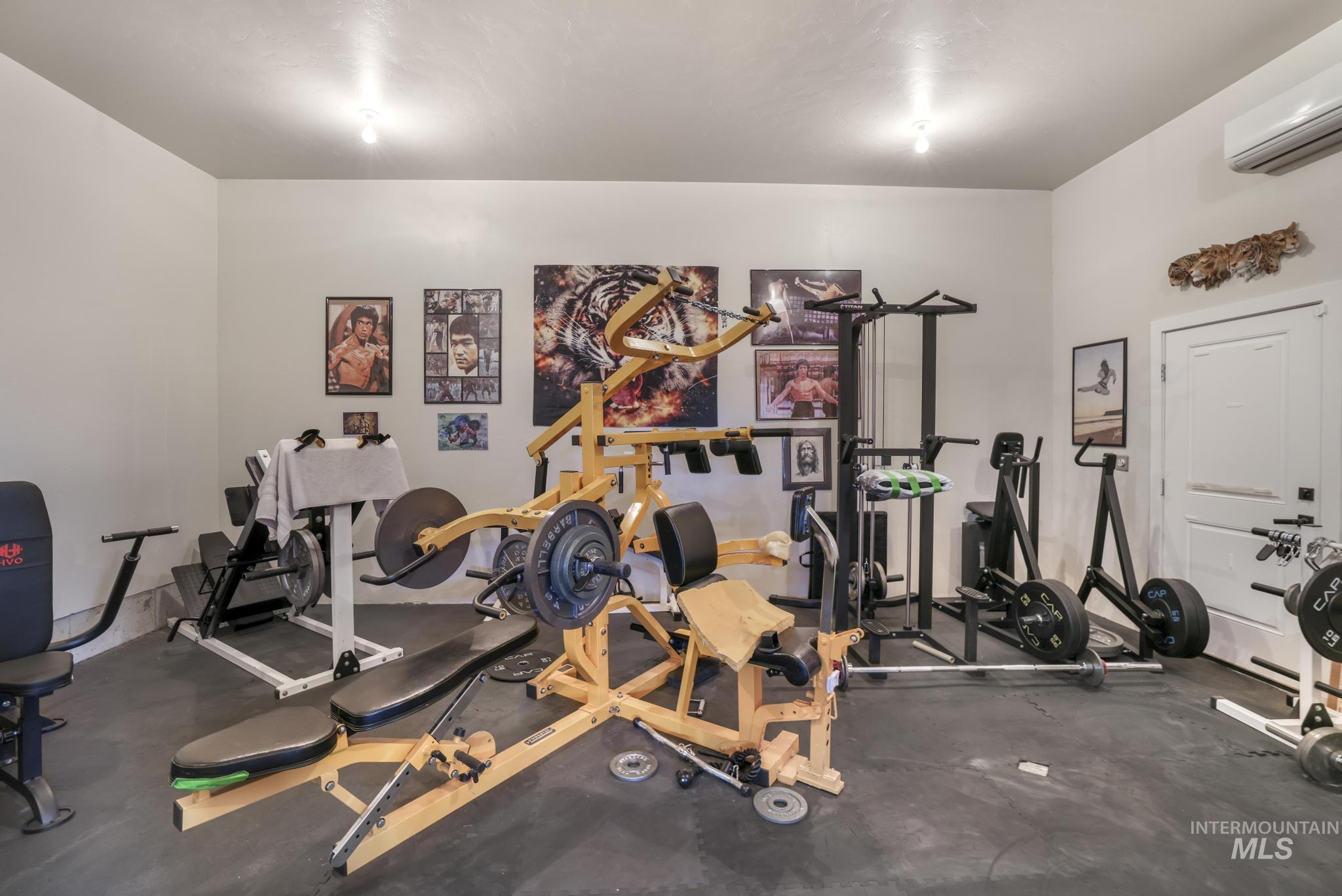 Workout area with rubber floors and a wall mounted AC