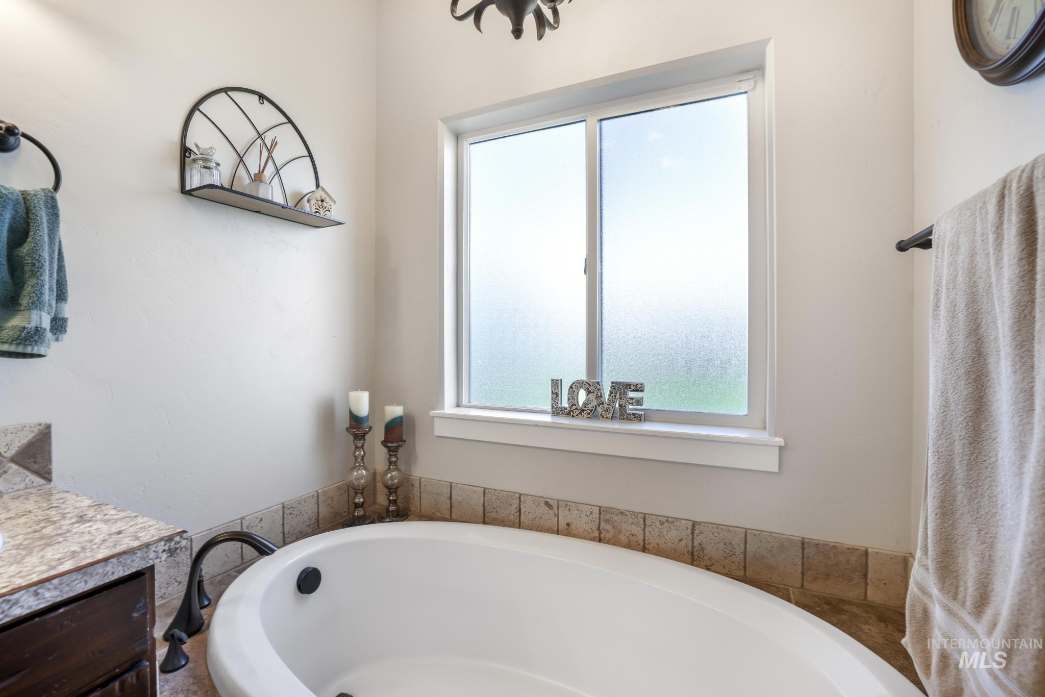 Bathroom featuring vanity and a garden tub