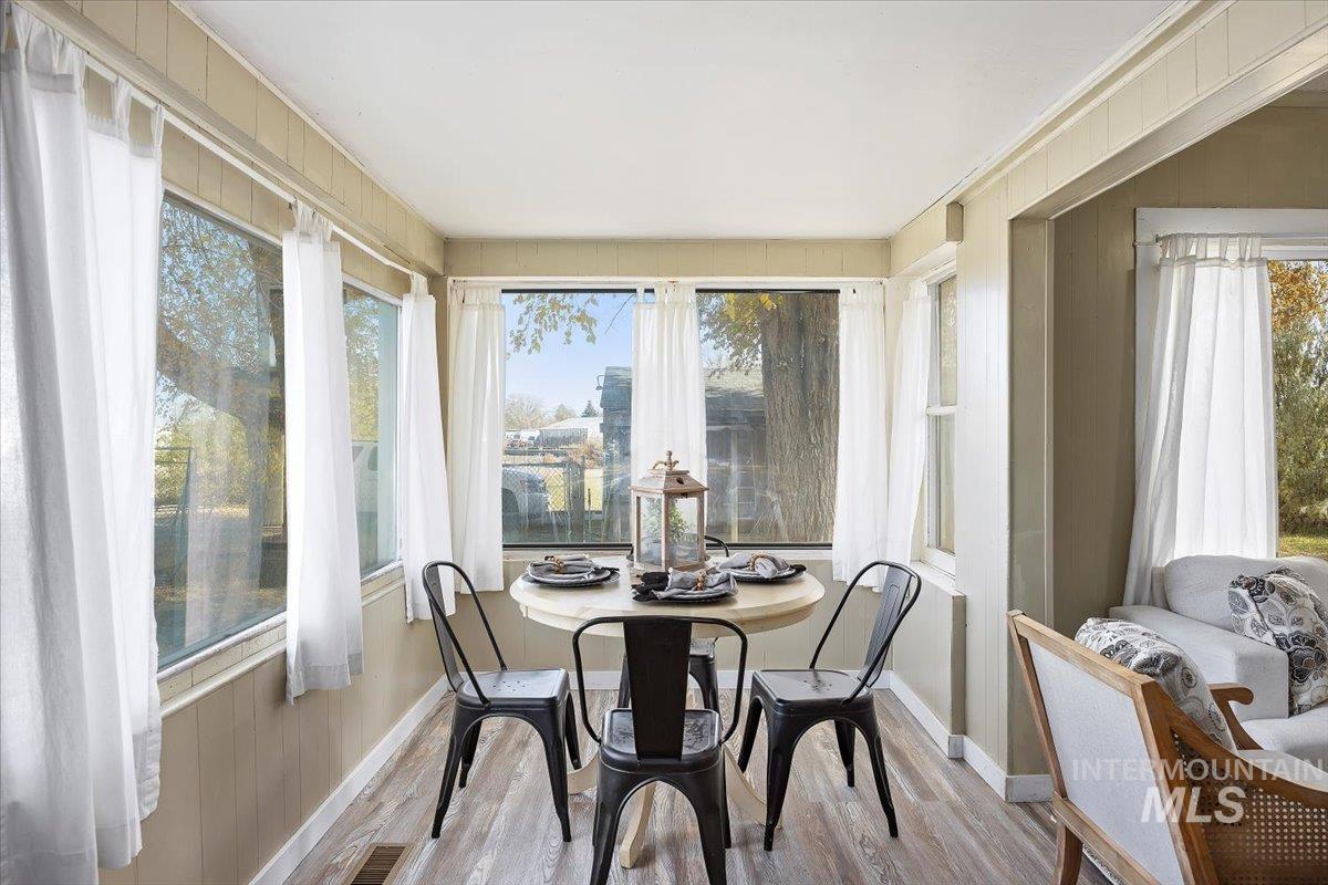 Sunroom / solarium with wood finished floors and wooden walls