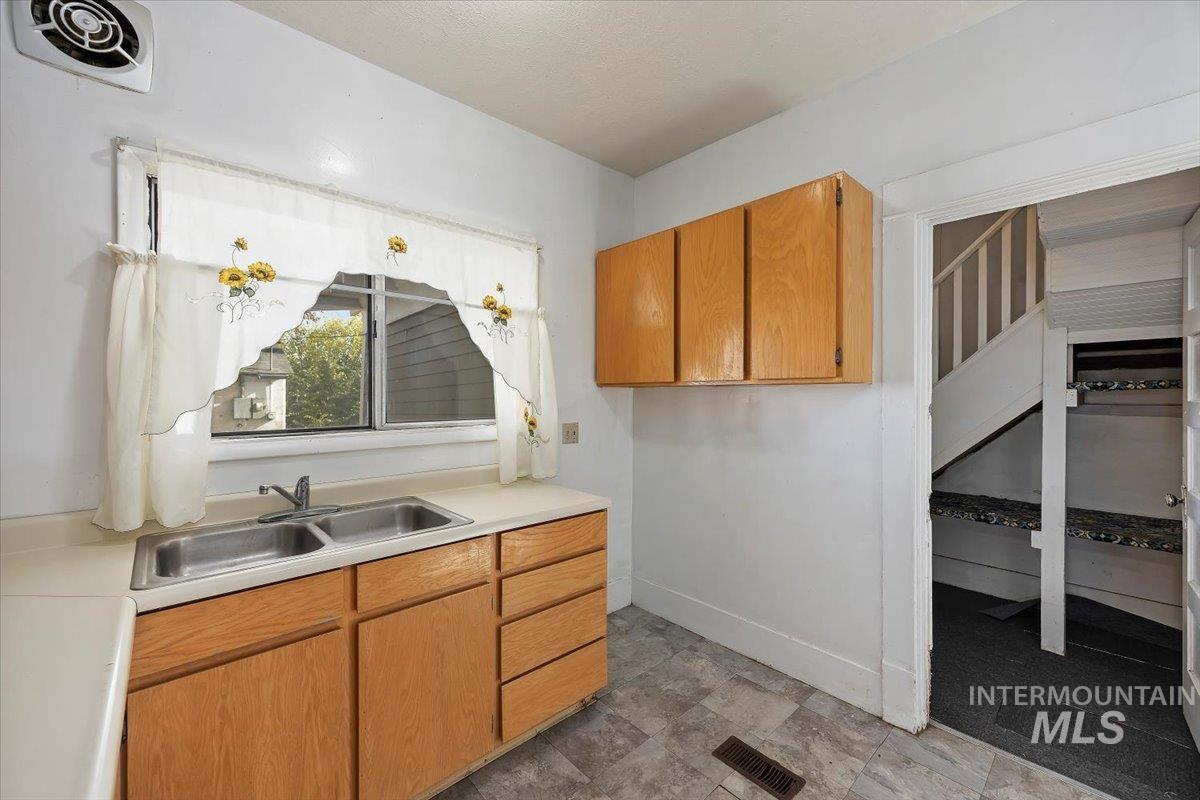 Kitchen featuring light countertops and brown cabinets