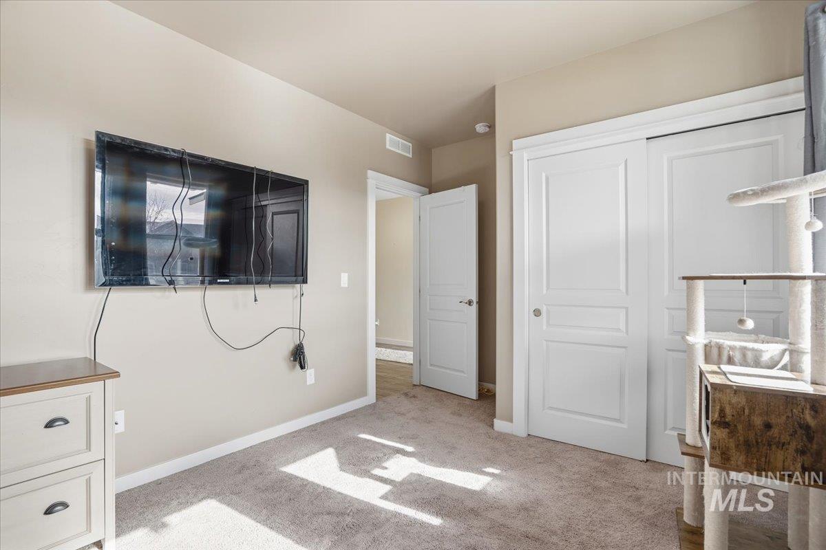 Unfurnished bedroom featuring light colored carpet and a closet