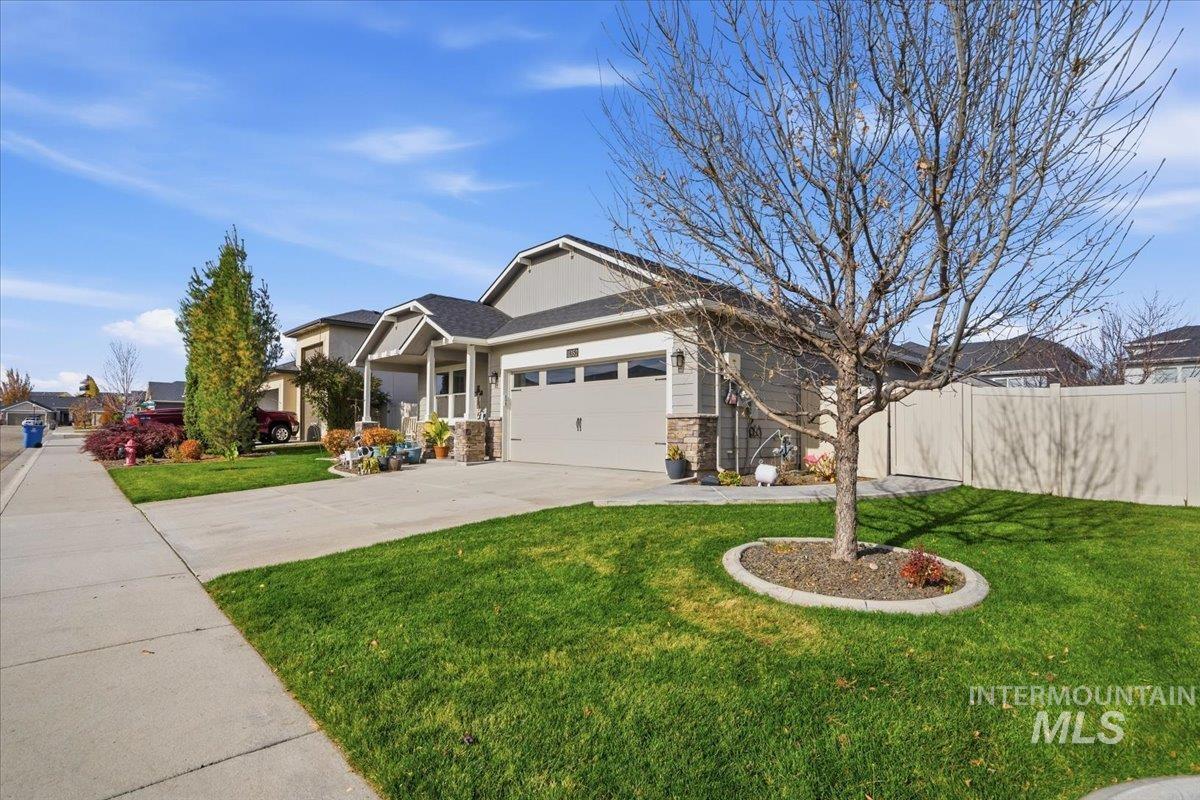 Craftsman-style home with concrete driveway, a garage, and stone siding