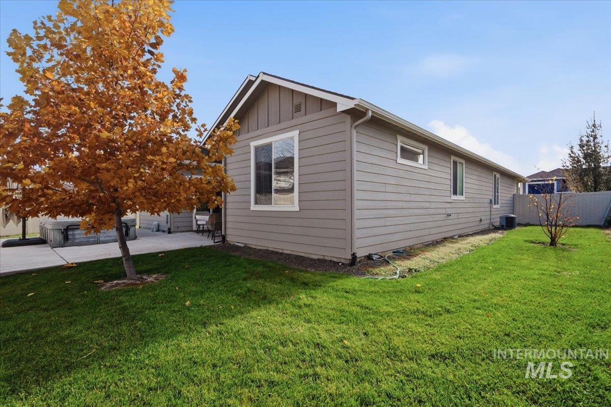 View of side of property featuring board and batten siding and a patio area