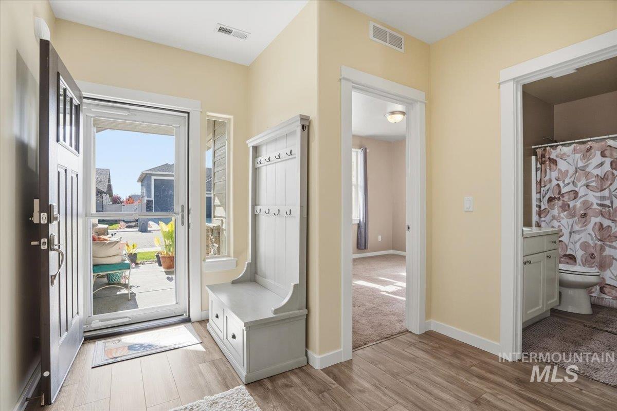 Foyer entrance featuring baseboards and light wood finished floors