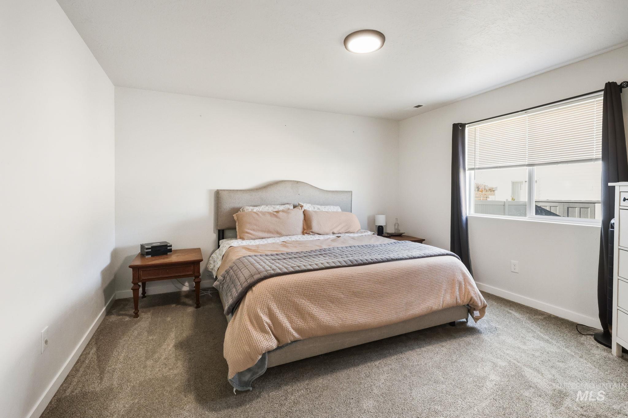 Carpeted bedroom with baseboards