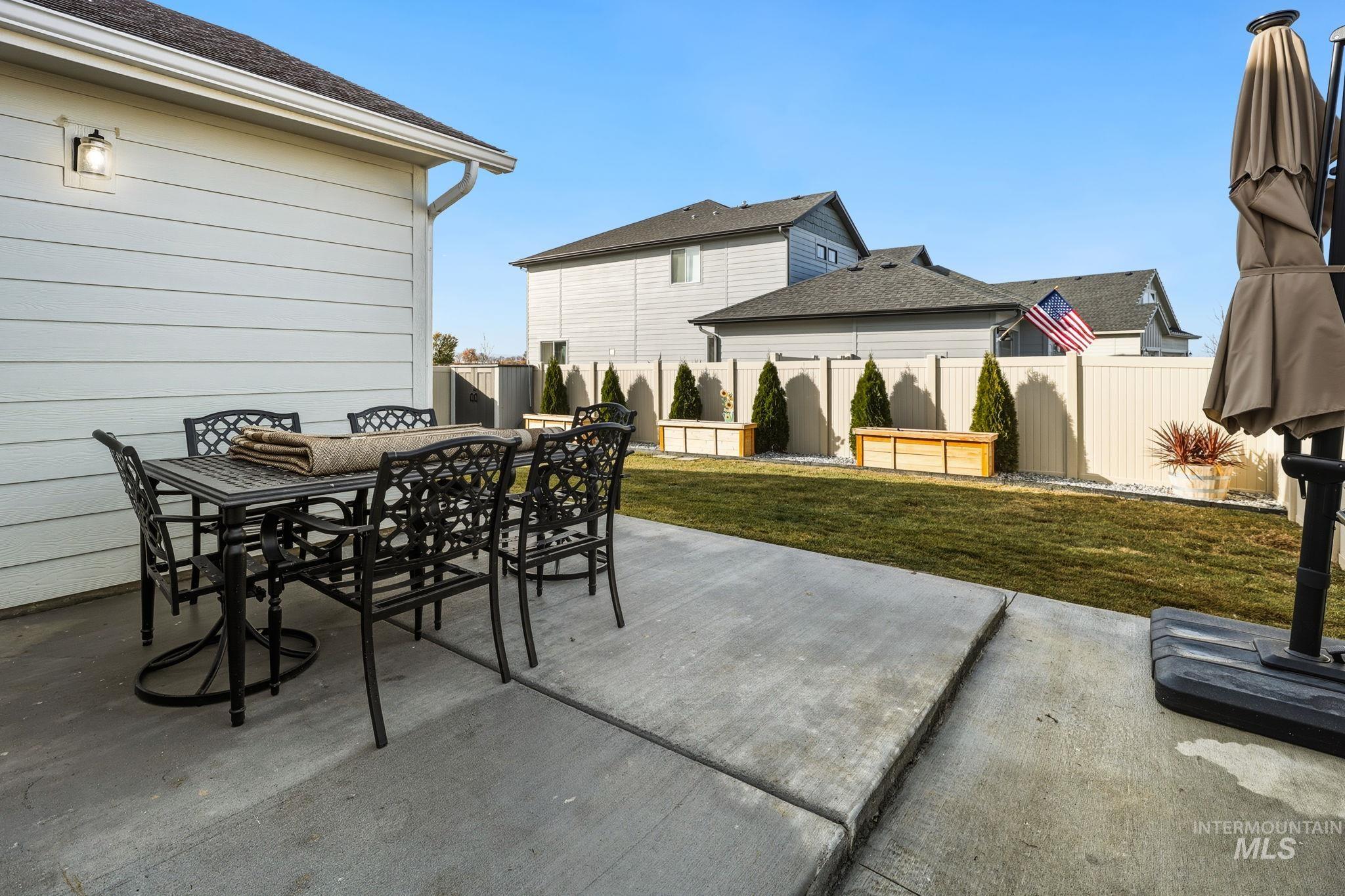 Fenced backyard with a patio area and outdoor dining area