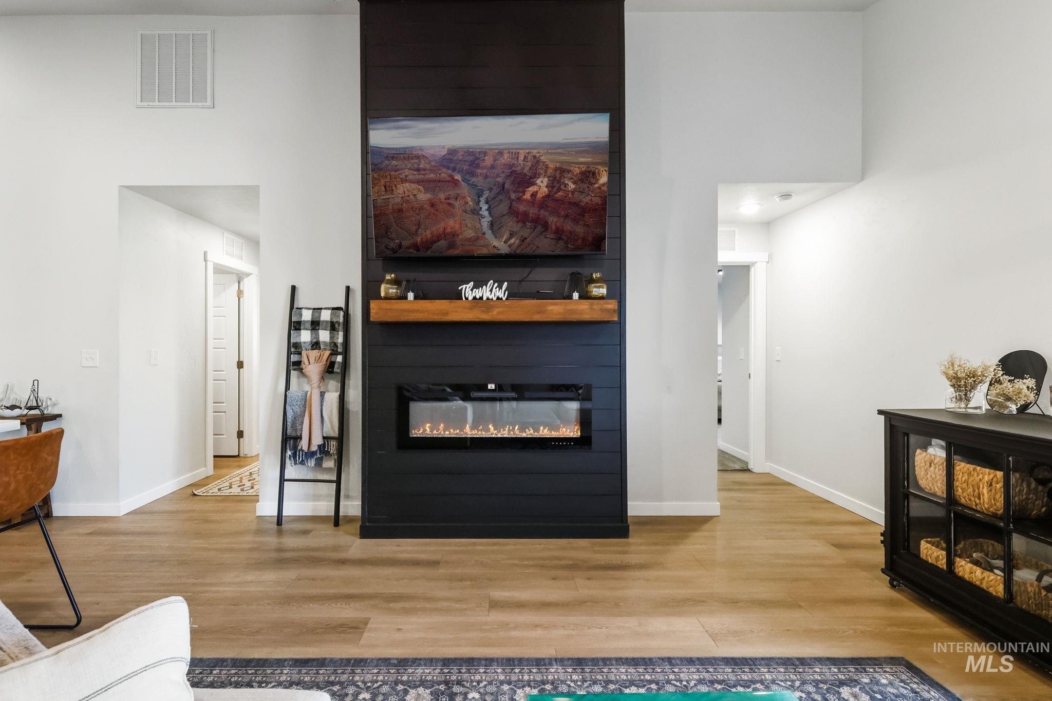 Detailed view of a fireplace and wood finished floors