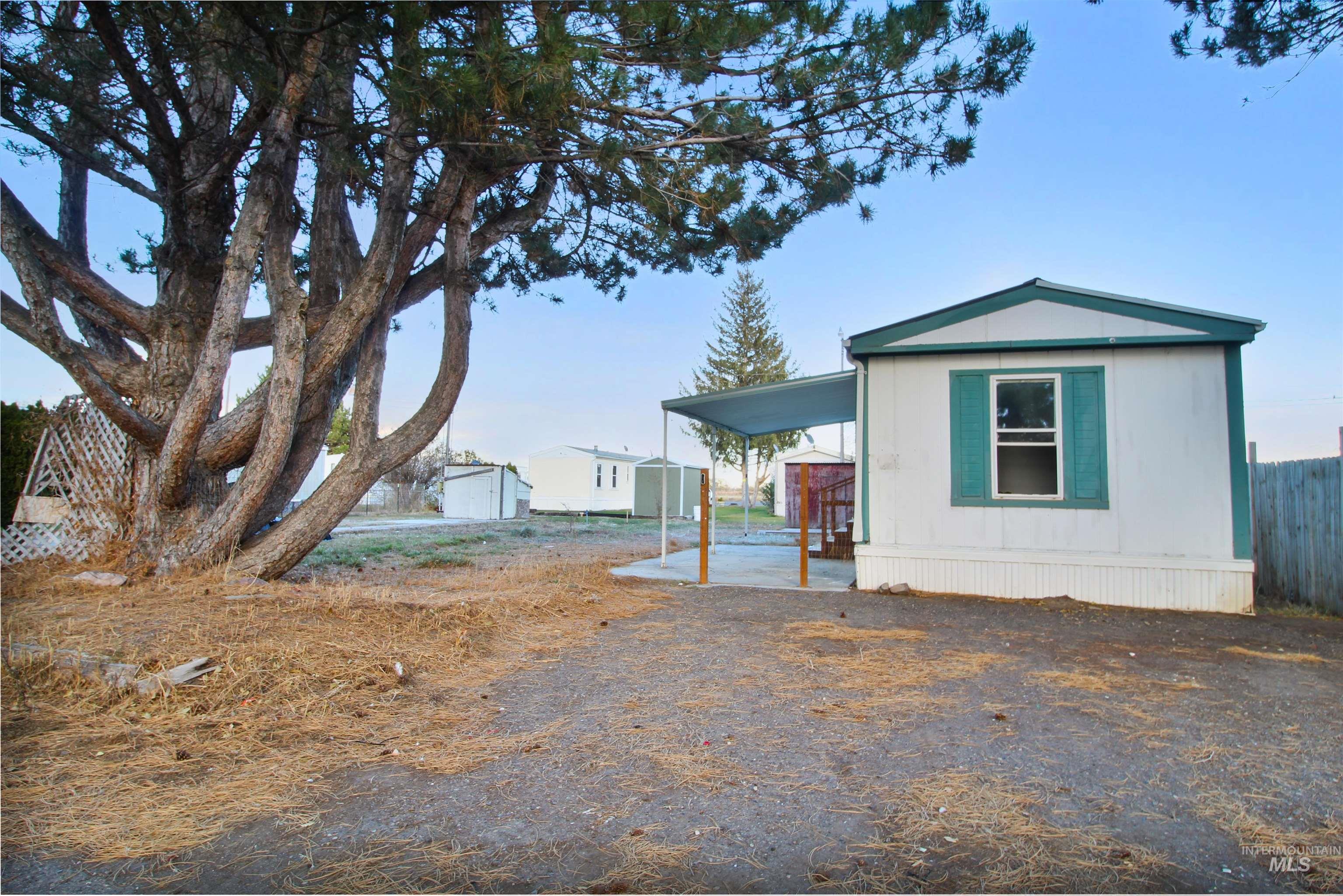 View of side of property with a storage shed