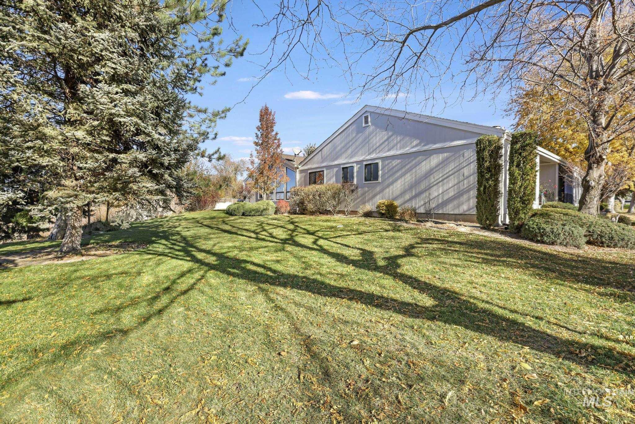 View of property exterior with a lawn