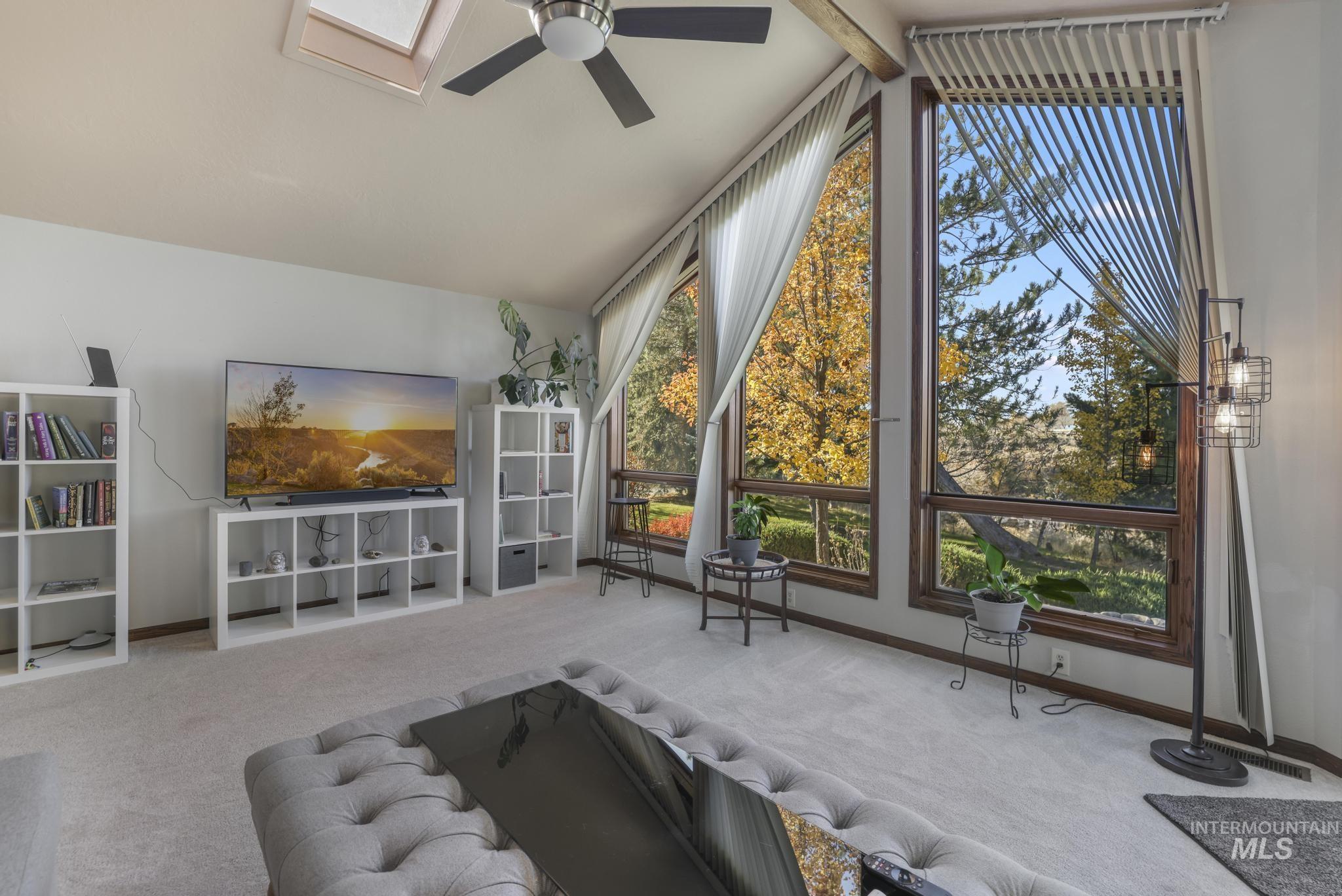 Living area with carpet floors and ceiling fan
