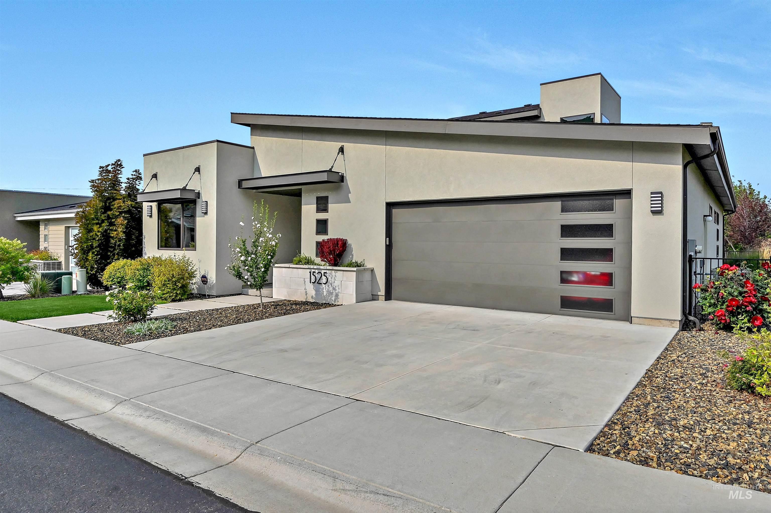 Modern home with stucco siding, driveway, and an attached garage