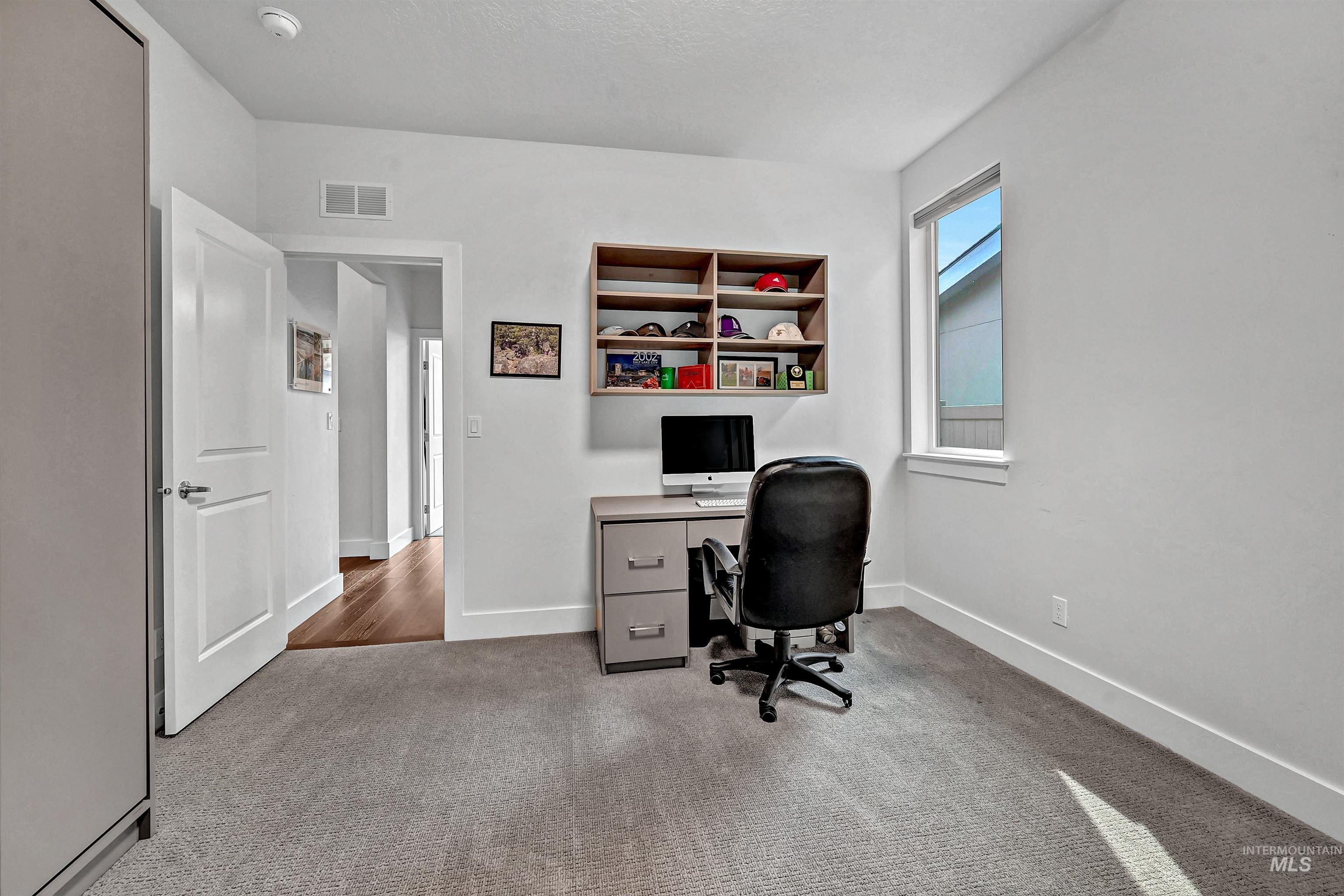 Office with light carpet and baseboards