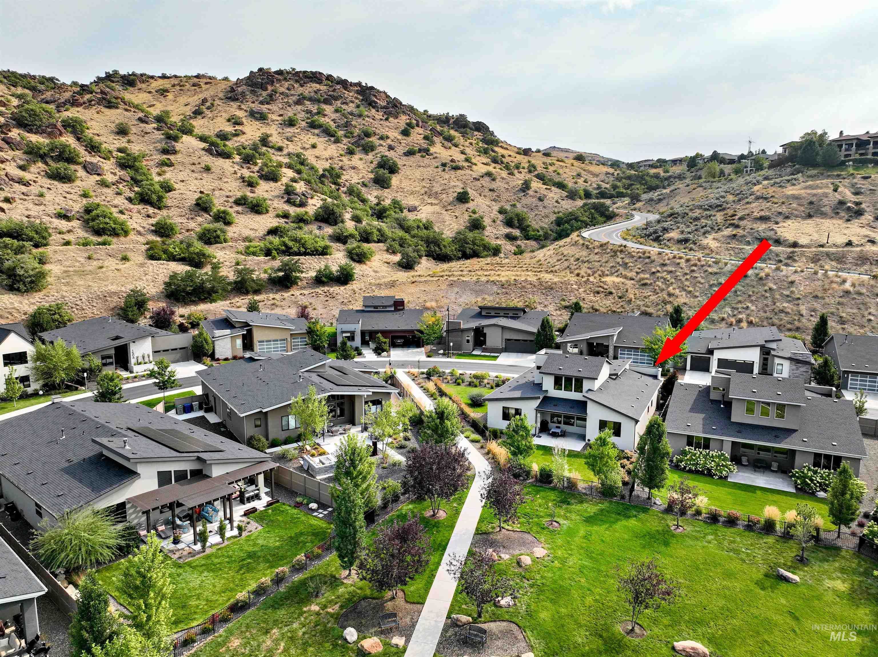 Aerial perspective of suburban area with a mountain backdrop