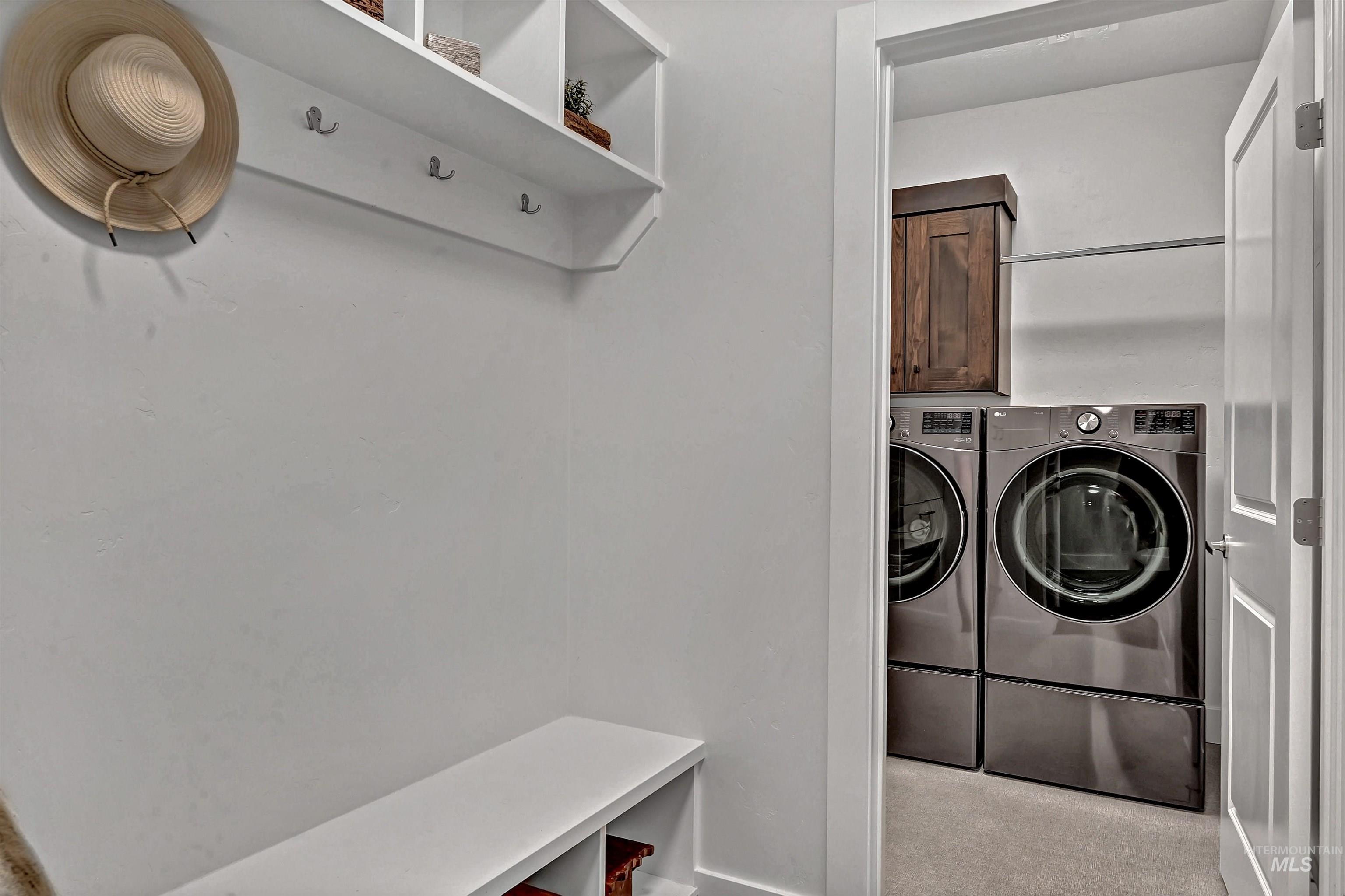 Washroom with carpet floors, separate washer and dryer, and cabinet space