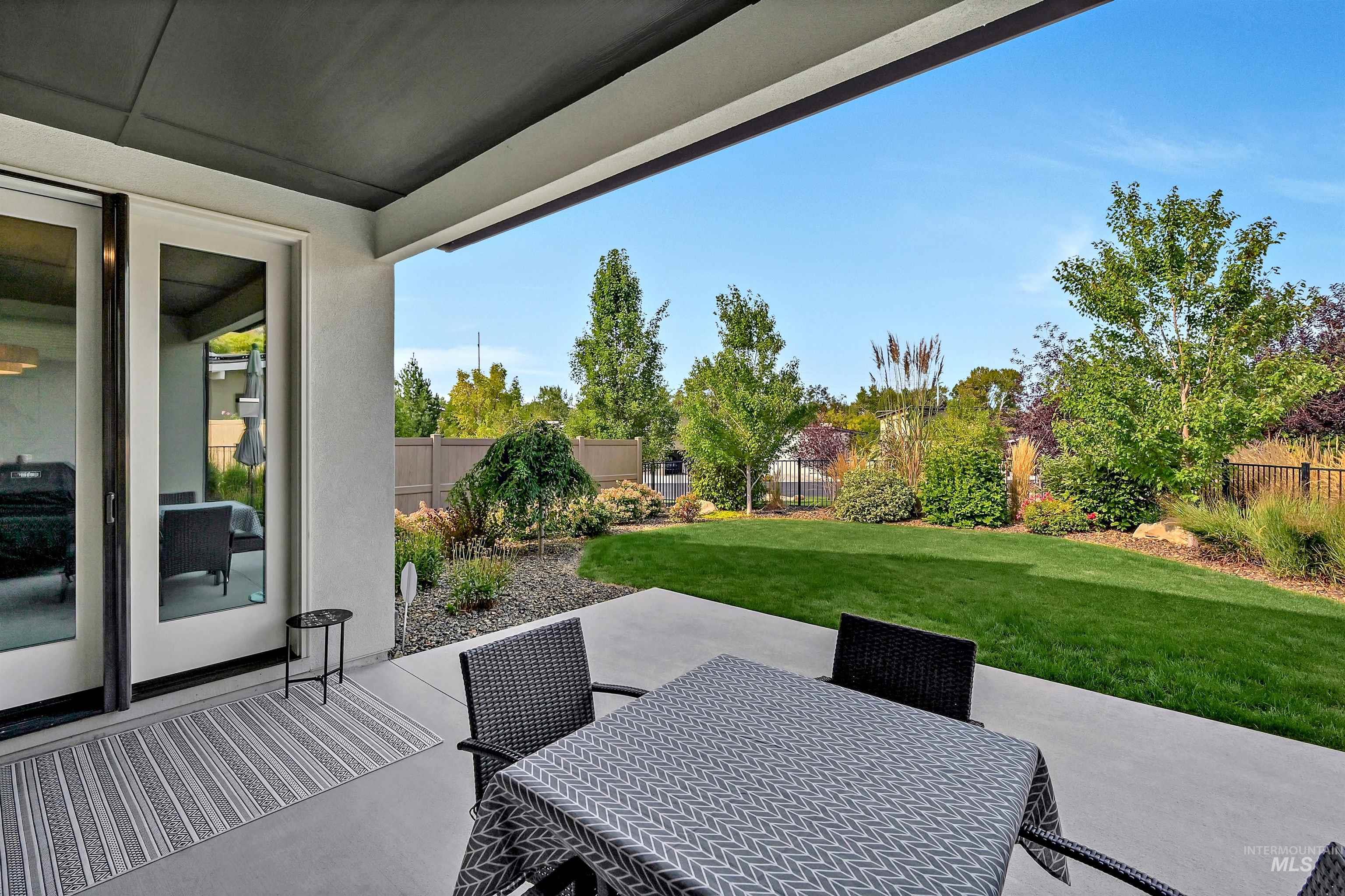 Fenced backyard with a patio and outdoor dining area