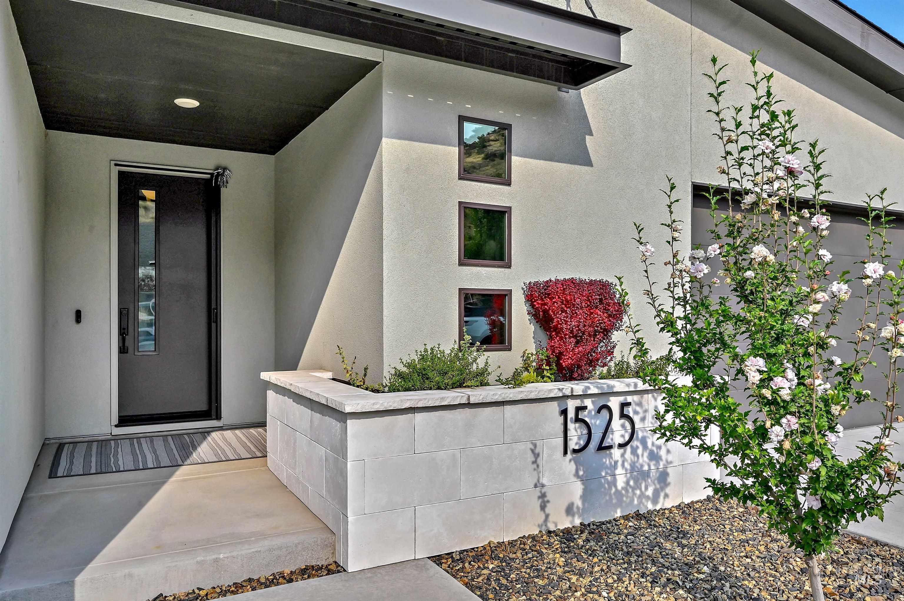 Entrance to property featuring stucco siding