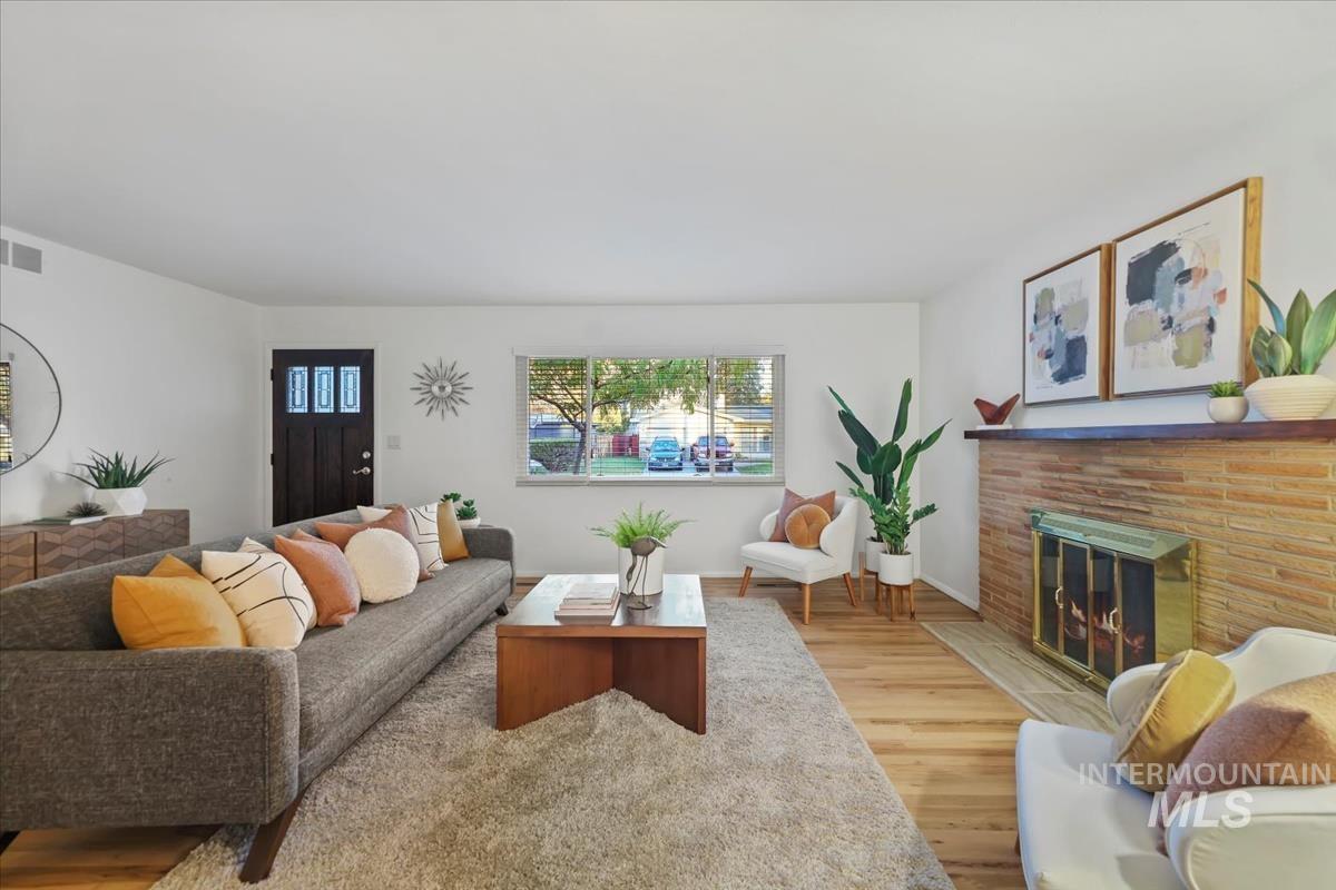 Living area featuring wood finished floors and a fireplace