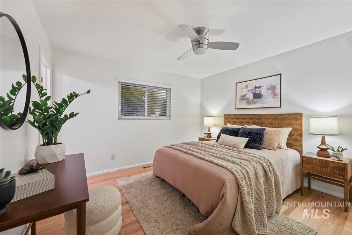 Bedroom with light wood finished floors and ceiling fan