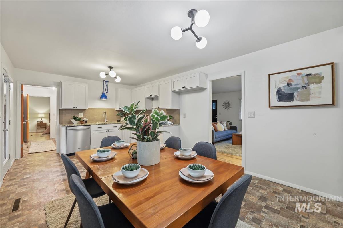 Dining area with stone finish floors and baseboards