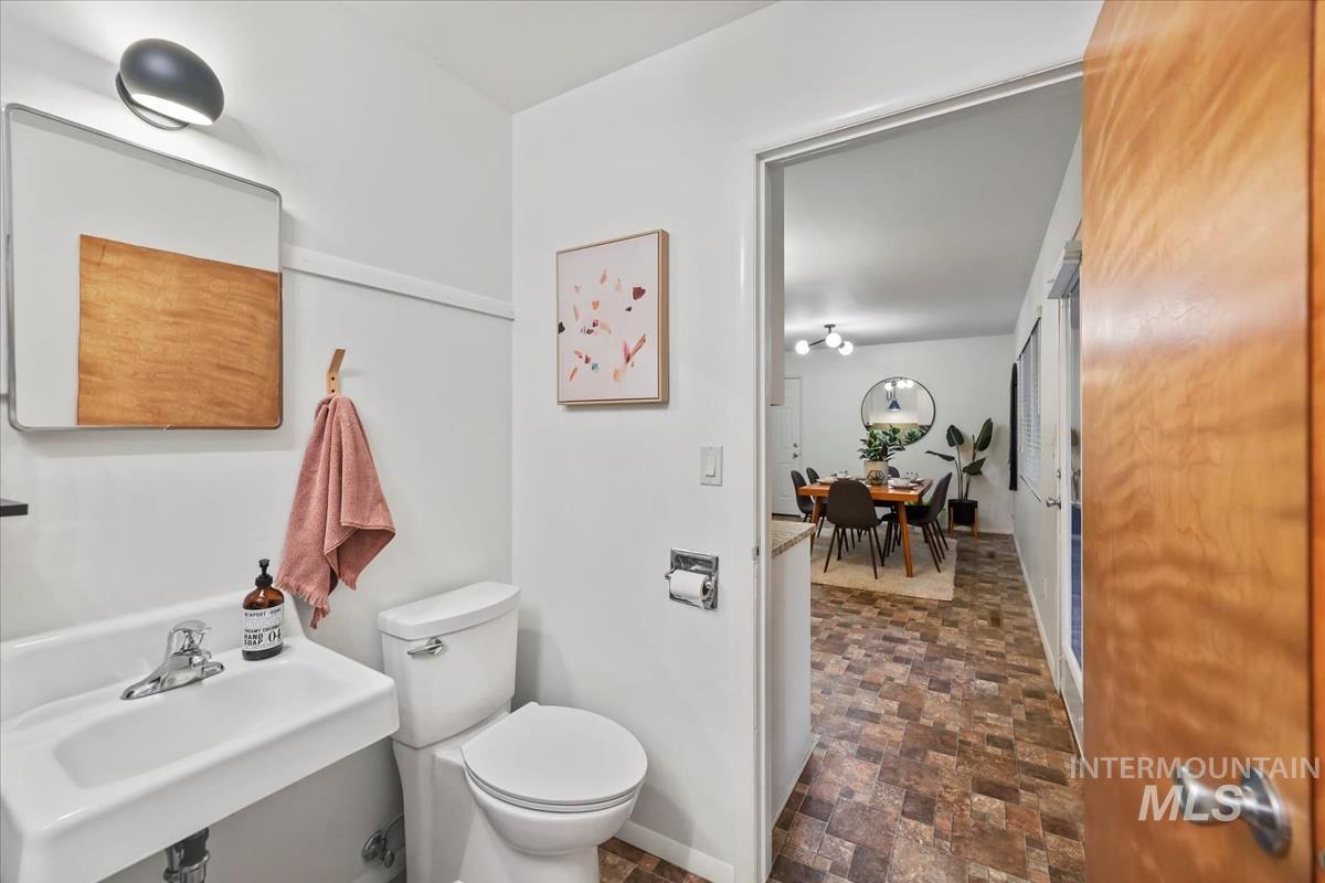 Bathroom featuring stone finish floors and toilet
