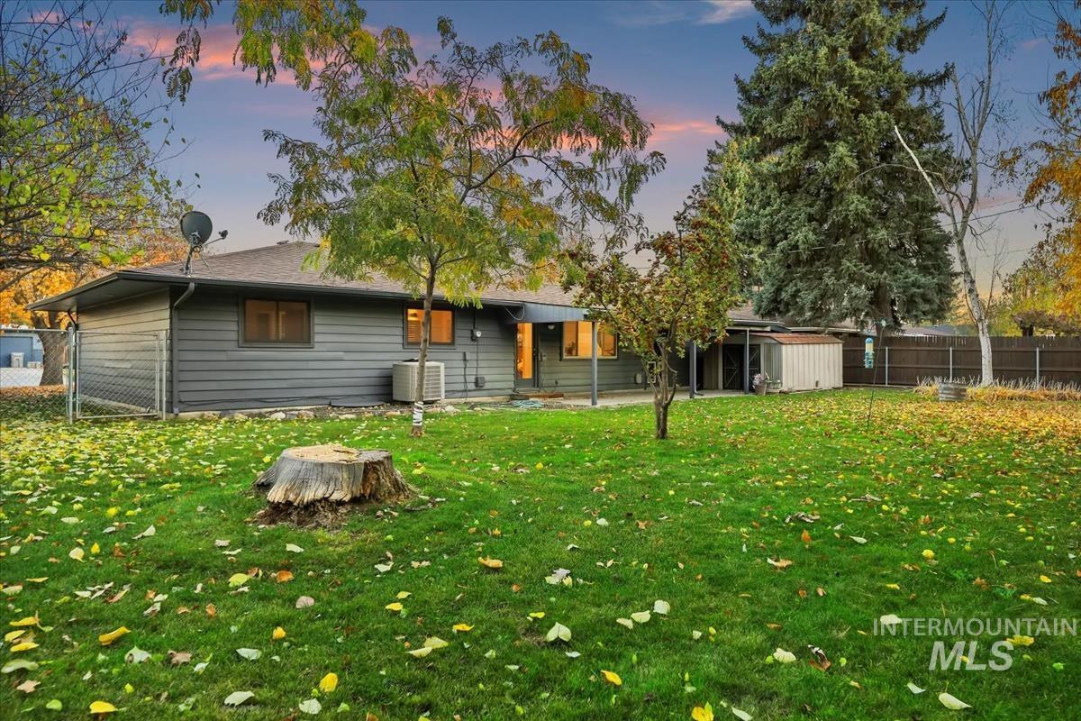 Back of house featuring a fenced backyard and a shed