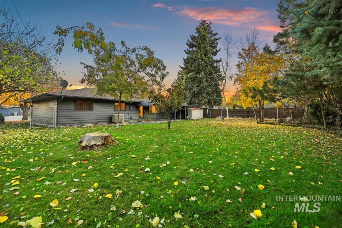 Yard at dusk with a fenced backyard