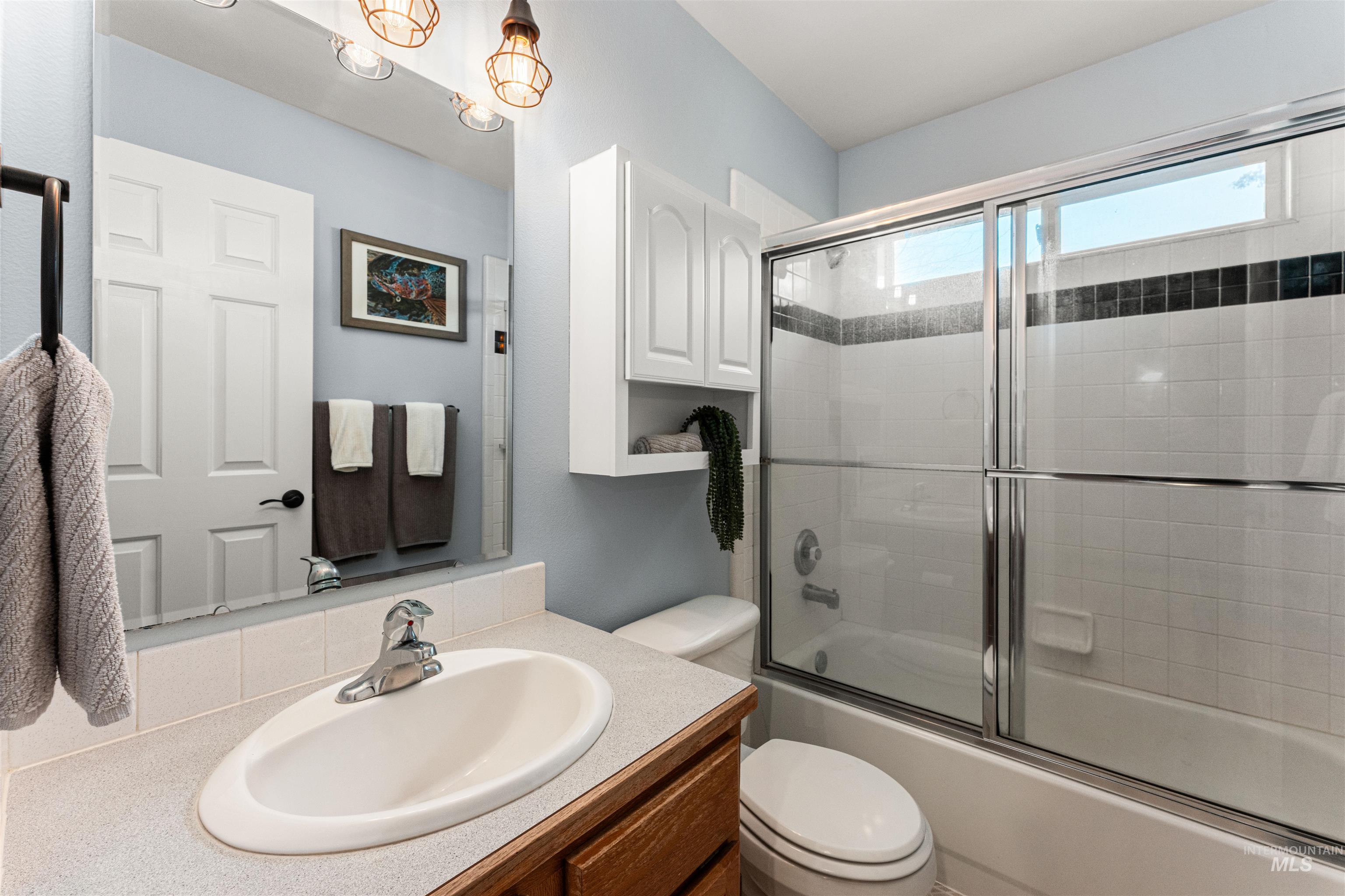 Full bathroom with vanity and shower / bath combination with glass door