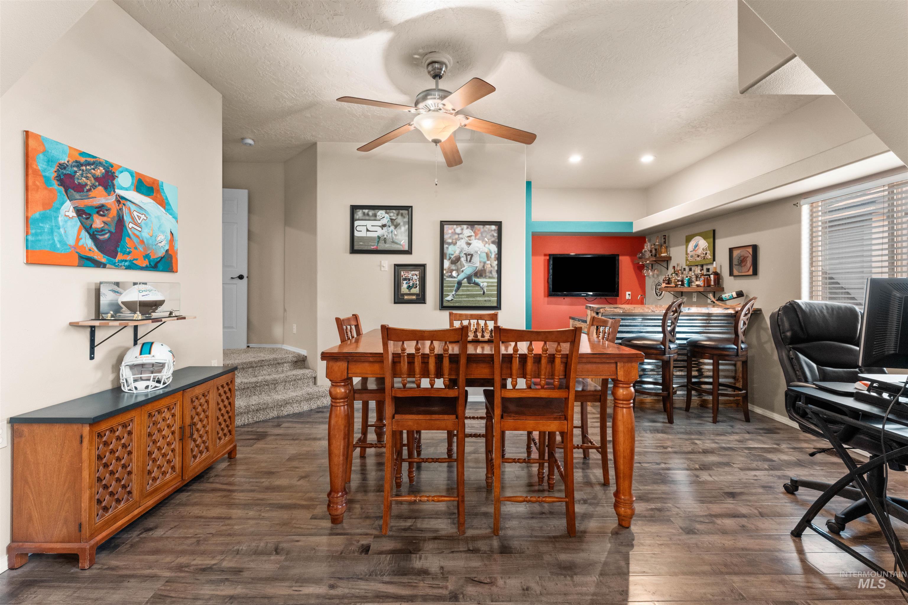 Dining space featuring stairway, dark wood-style floors, a textured ceiling, recessed lighting, and a ceiling fan