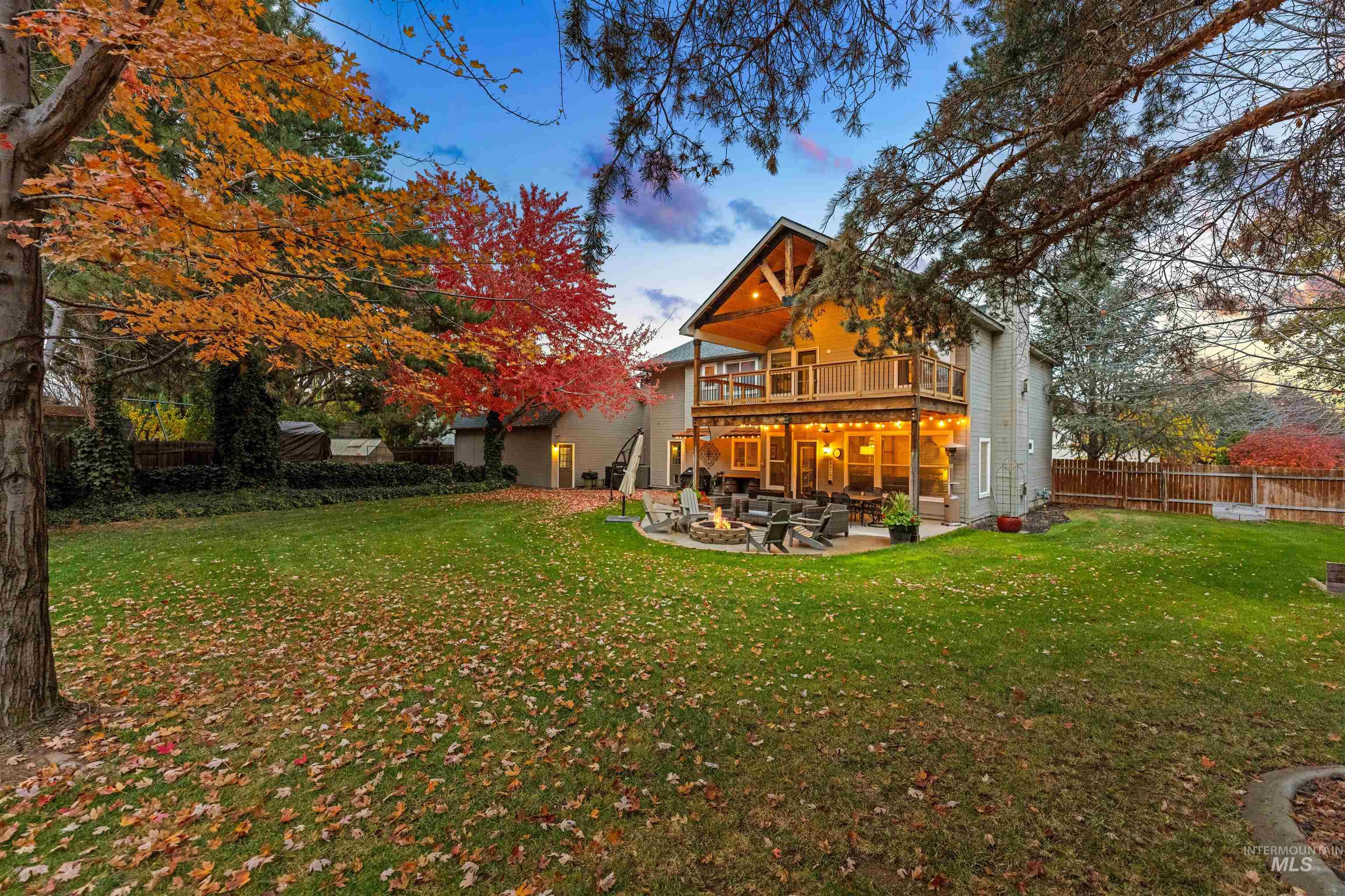 Back of property featuring a patio area, a fire pit, and a deck