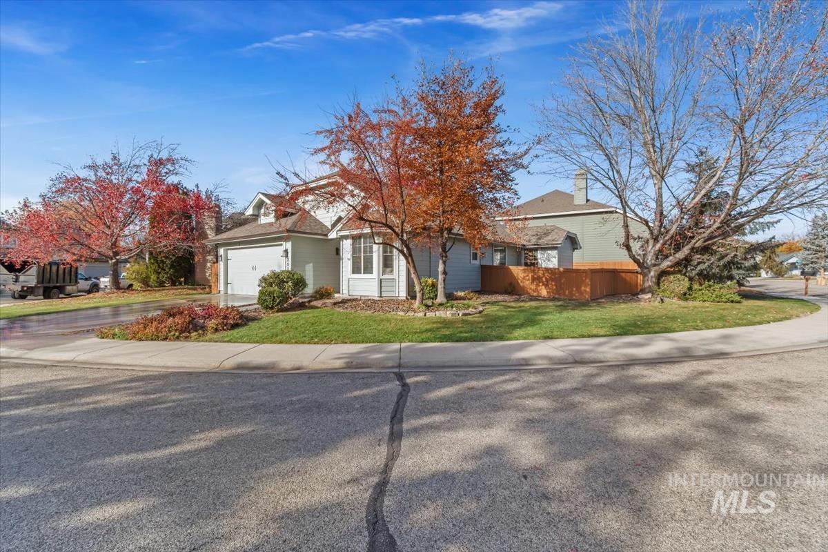 View of front of house with concrete driveway and an attached garage