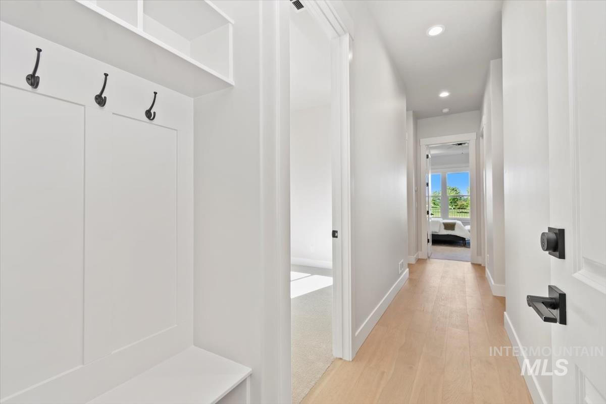 Mudroom featuring light wood finished floors and recessed lighting