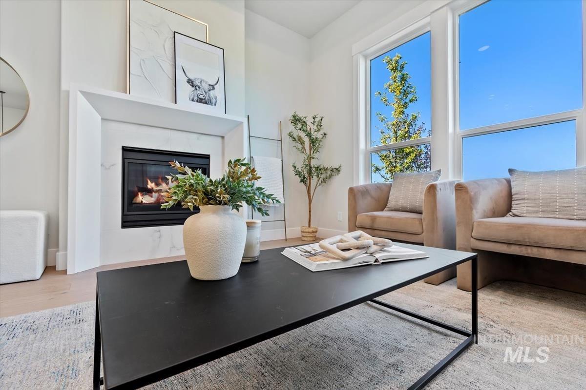 Living area featuring a glass covered fireplace and light wood finished floors