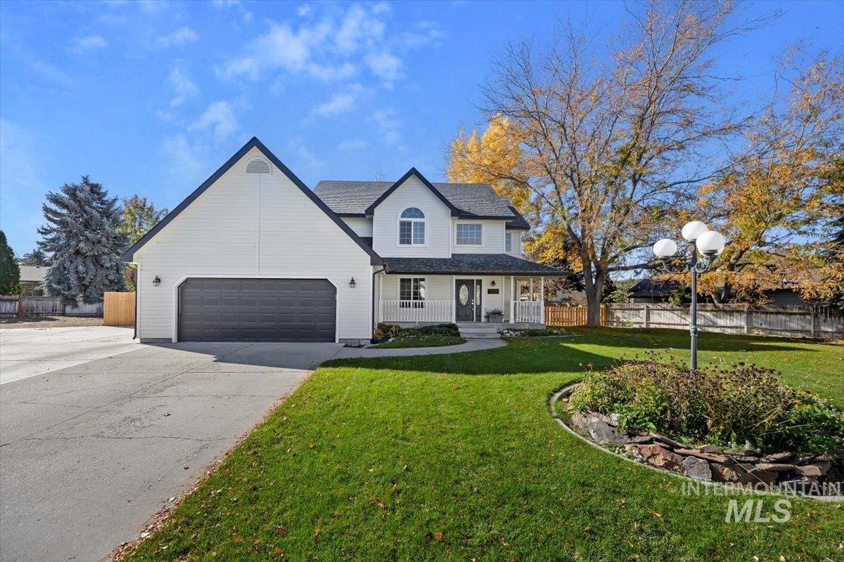 Traditional-style house with a porch and concrete driveway