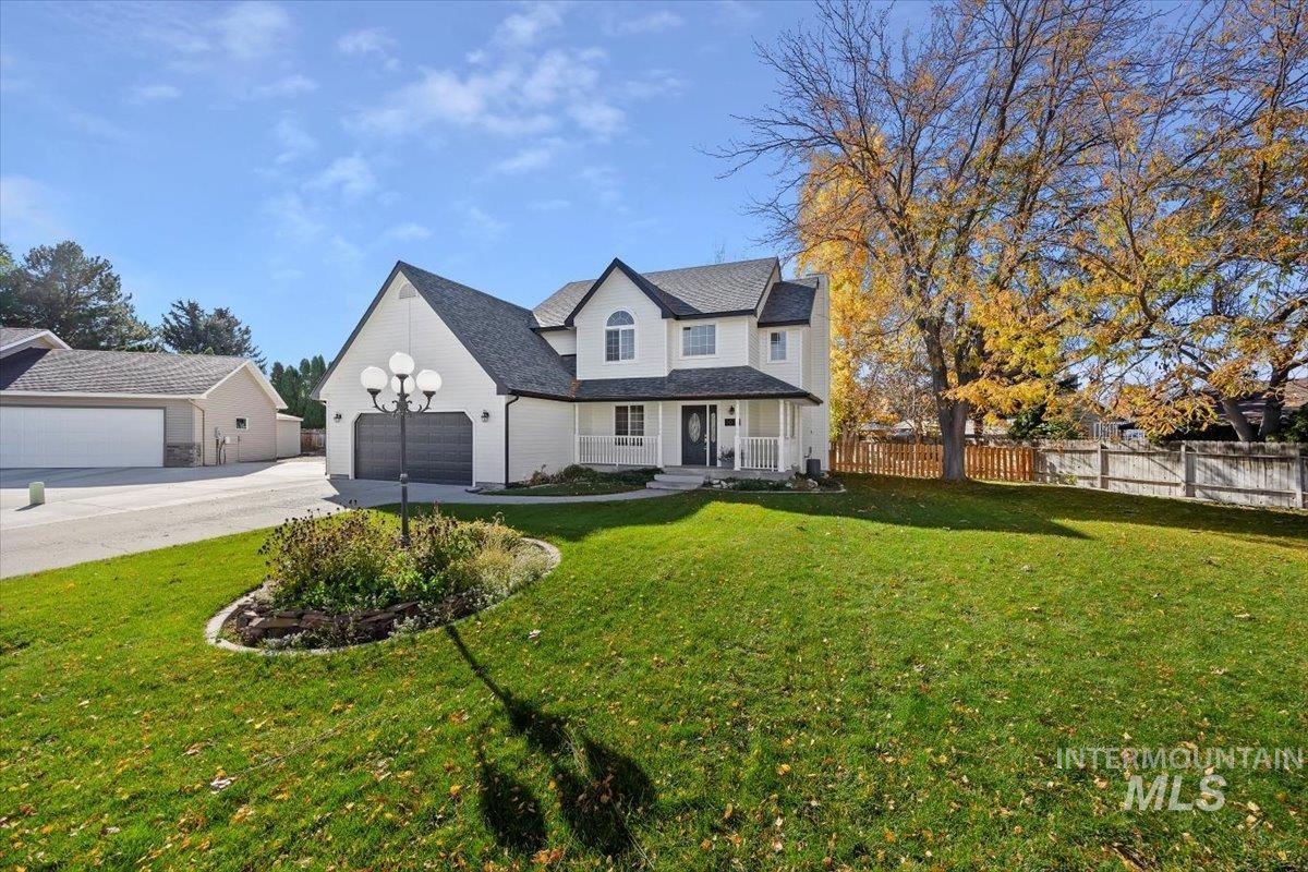 View of front of house featuring a porch, a garage, and concrete driveway