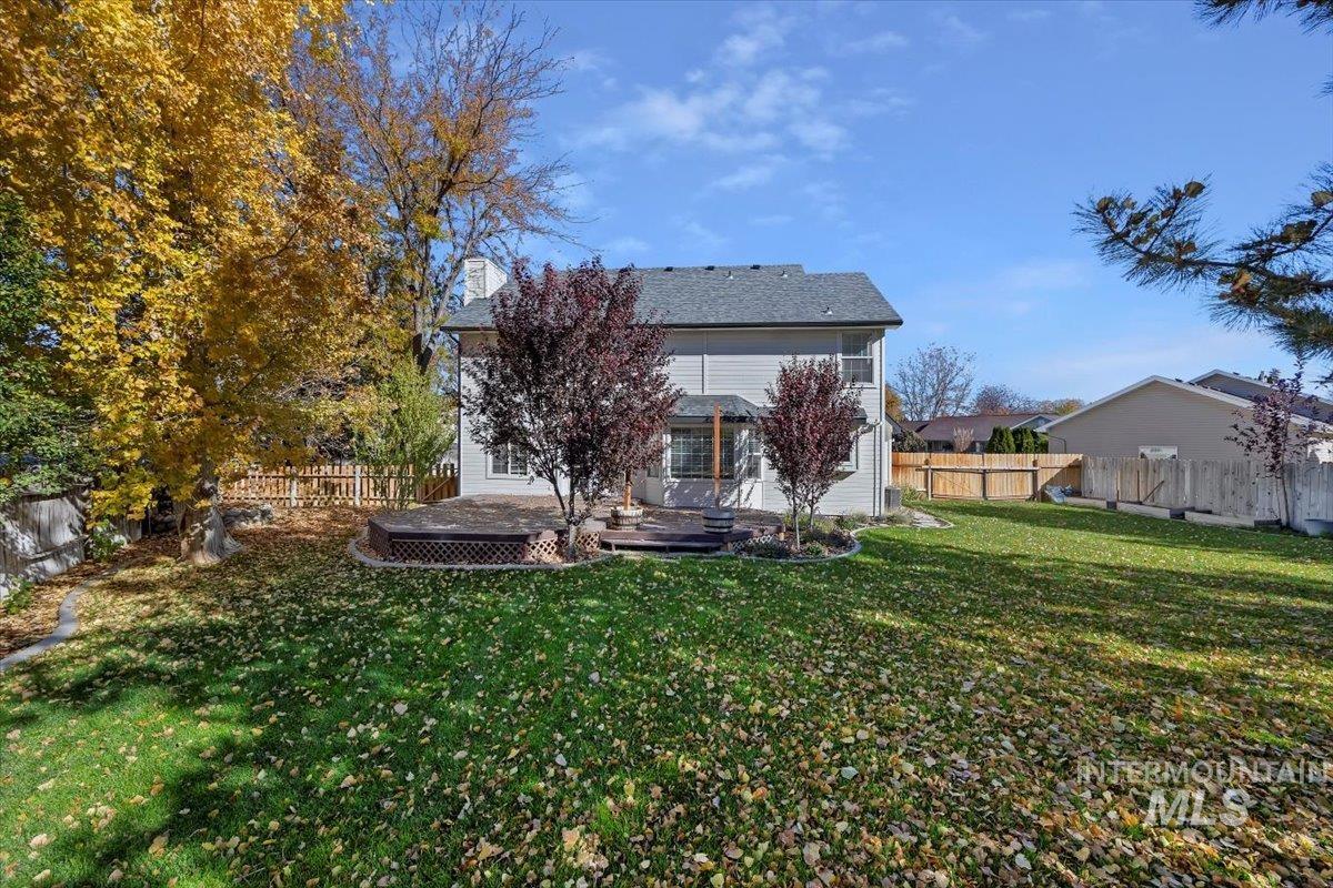 Rear view of property with a deck and a fenced backyard