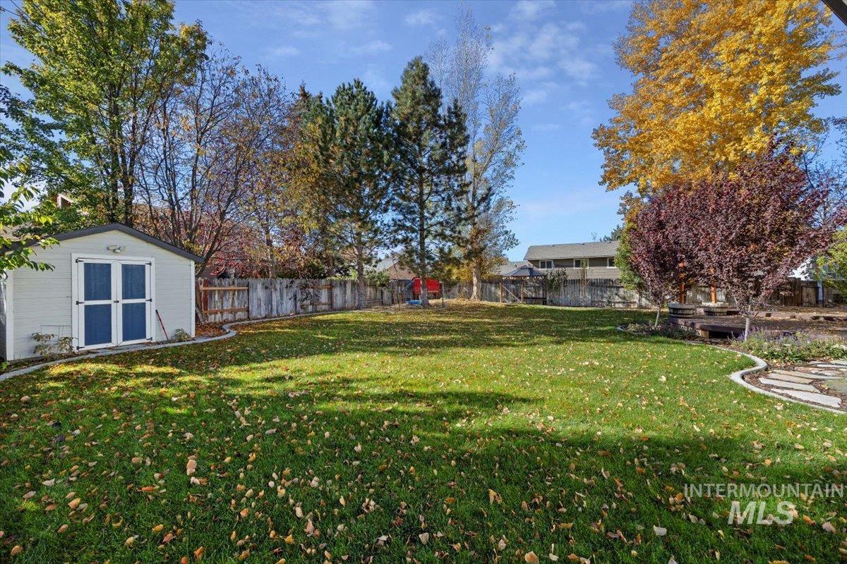 Fenced backyard with a shed