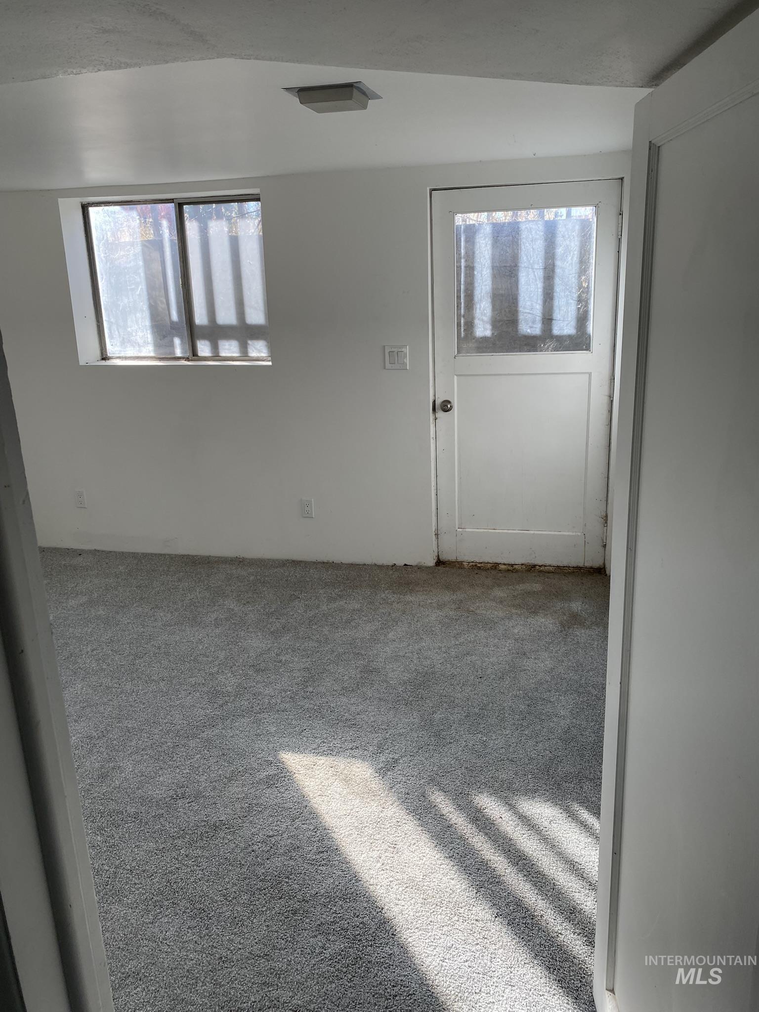Carpeted empty room with plenty of natural light
