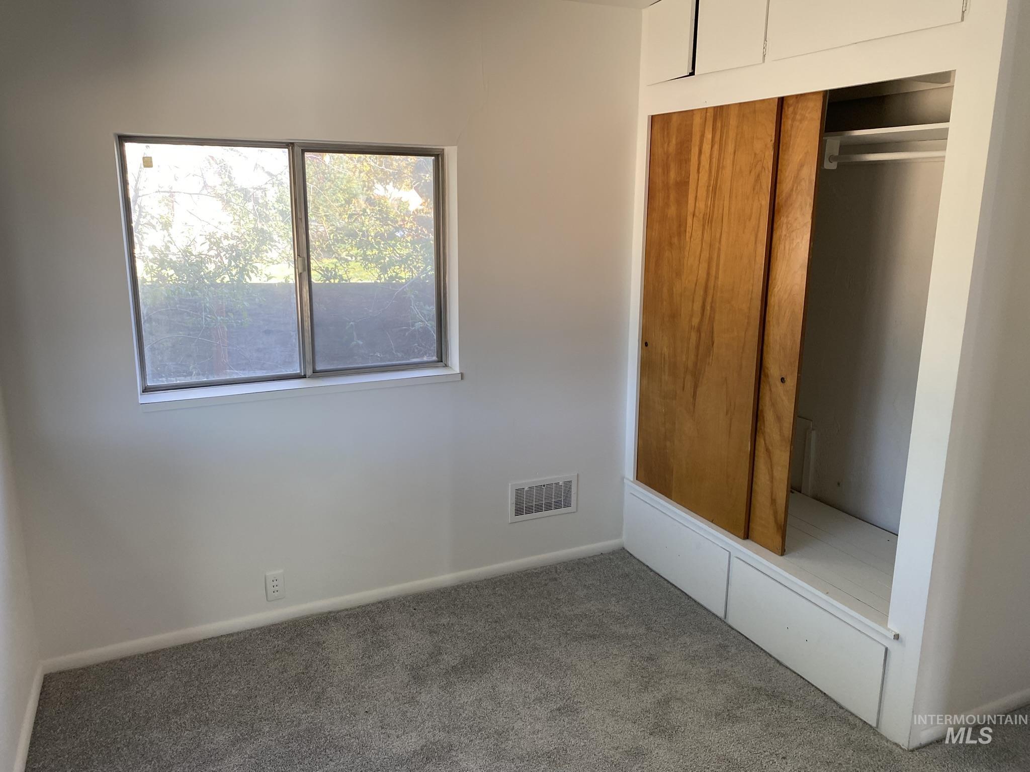 Unfurnished bedroom with carpet and a closet