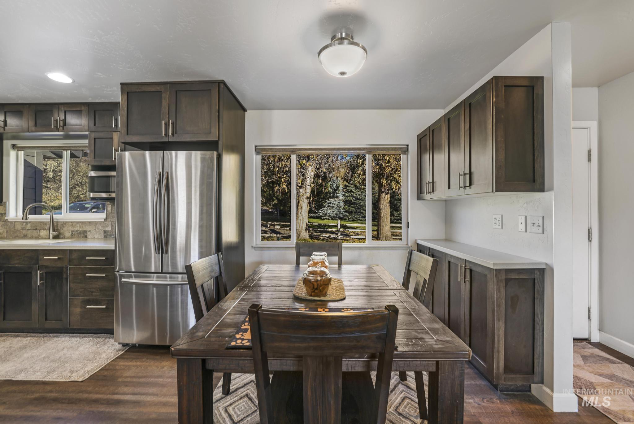 Dining room with dark wood-type flooring