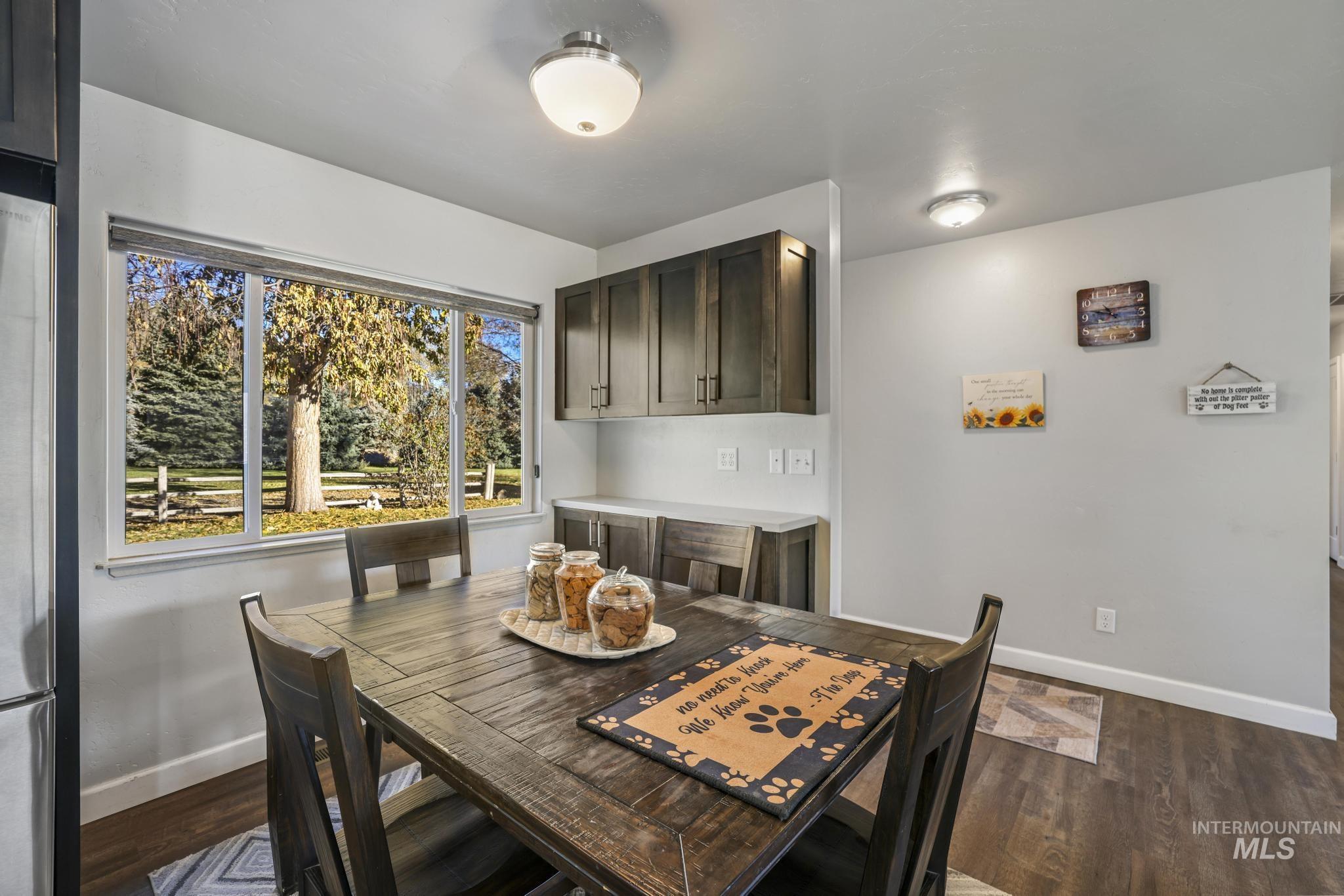 Dining space featuring baseboards and dark wood finished floors
