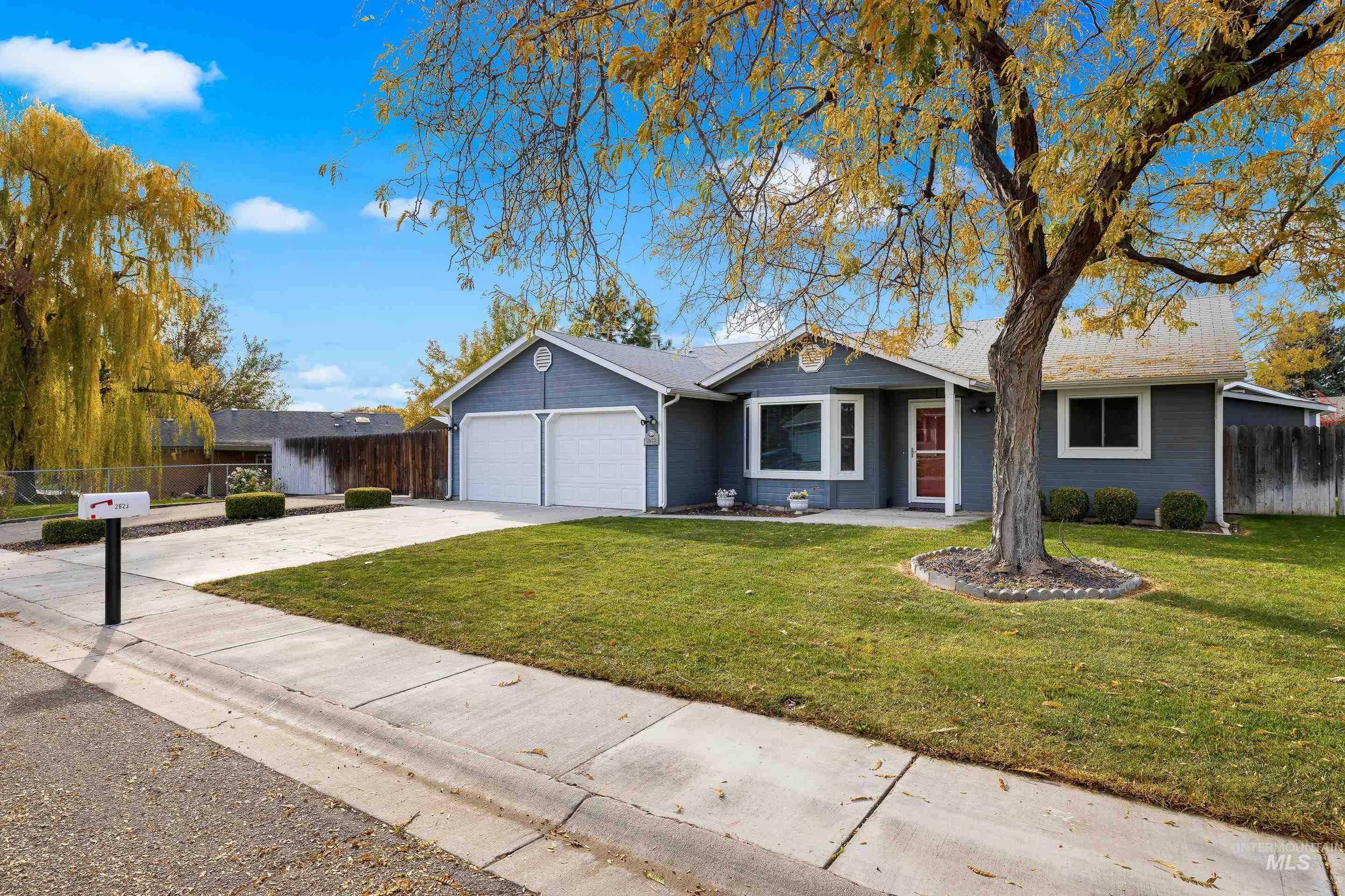 Ranch-style home featuring driveway and a garage