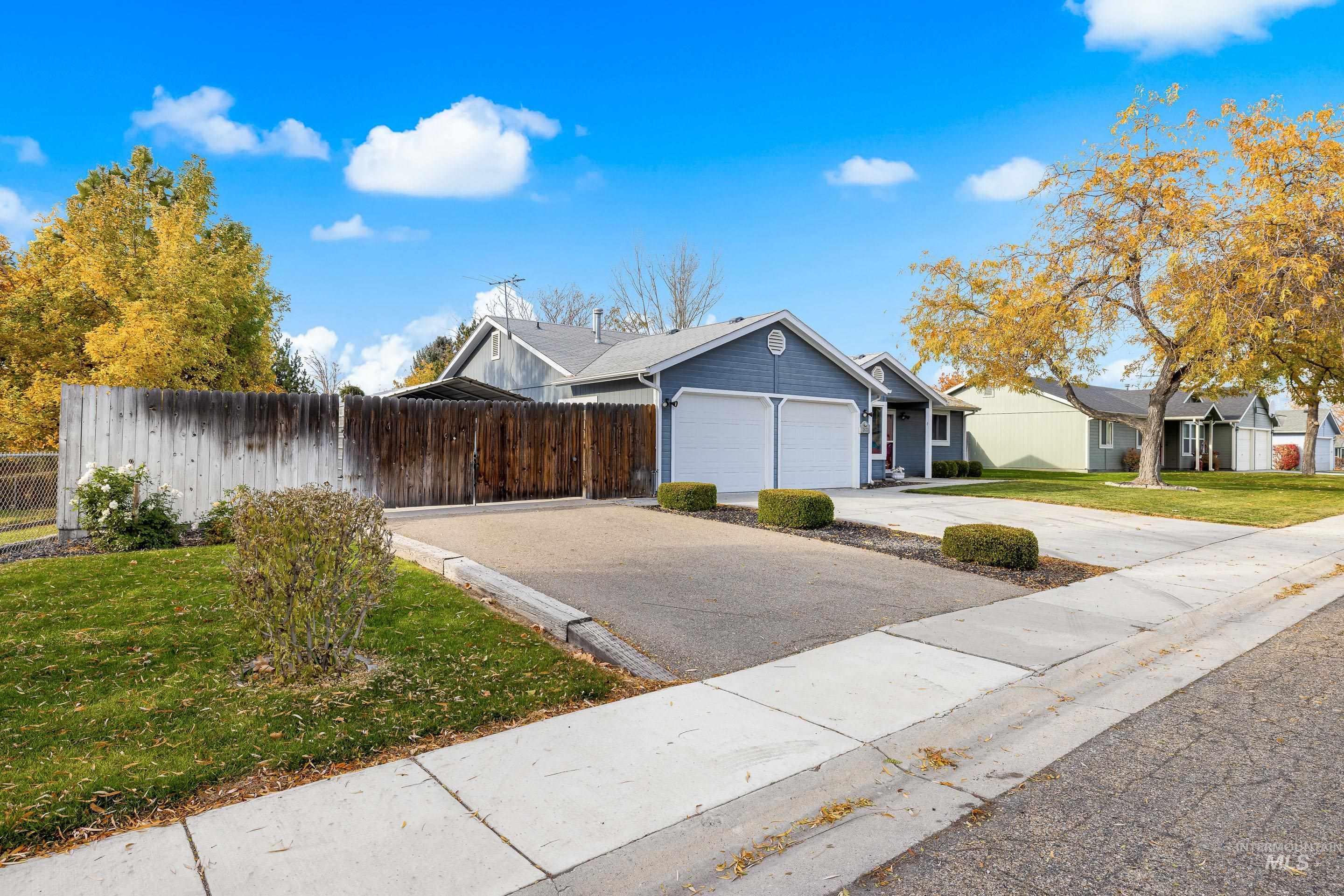 View of front of home with concrete driveway and a garage
