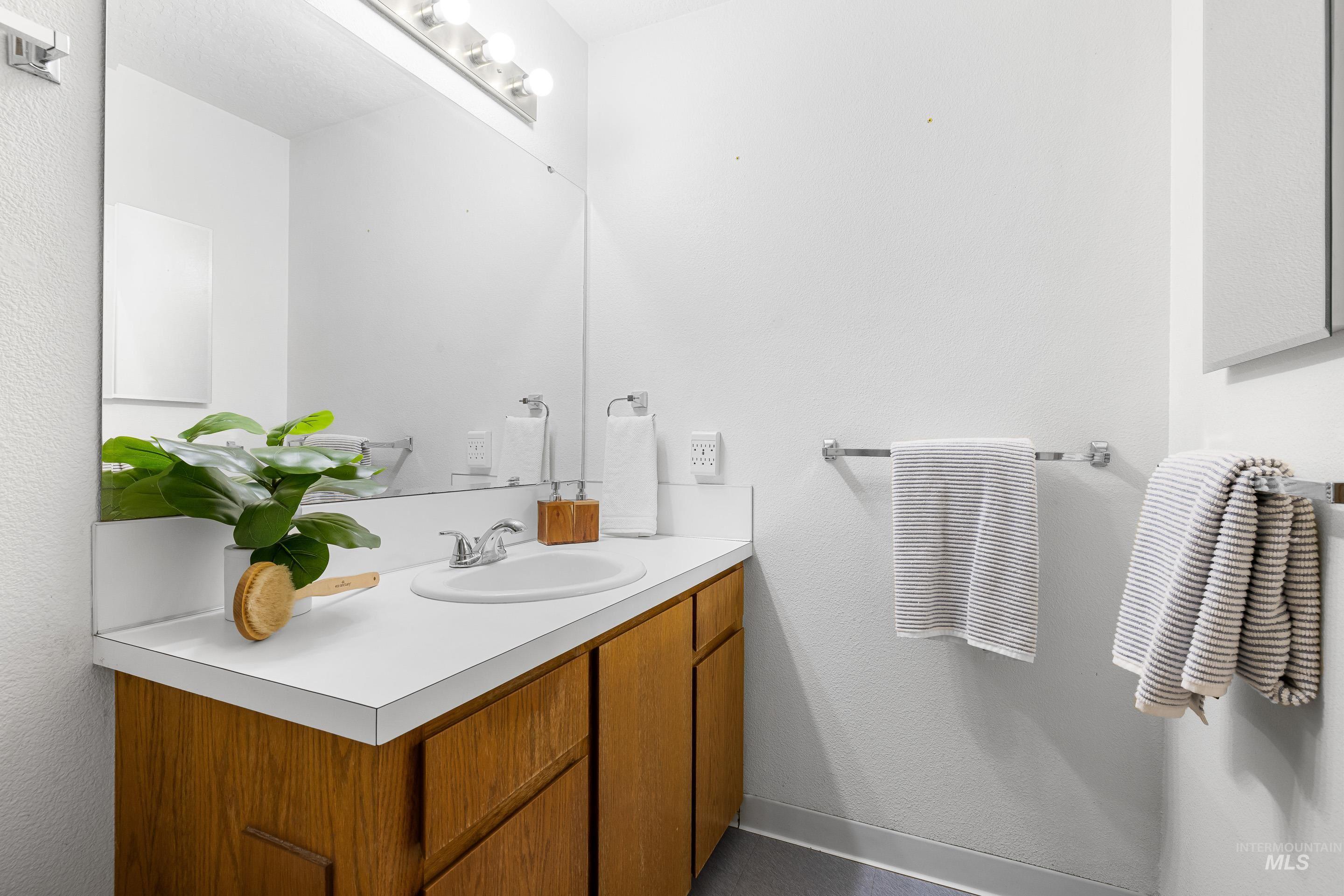 Bathroom featuring vanity and a textured wall