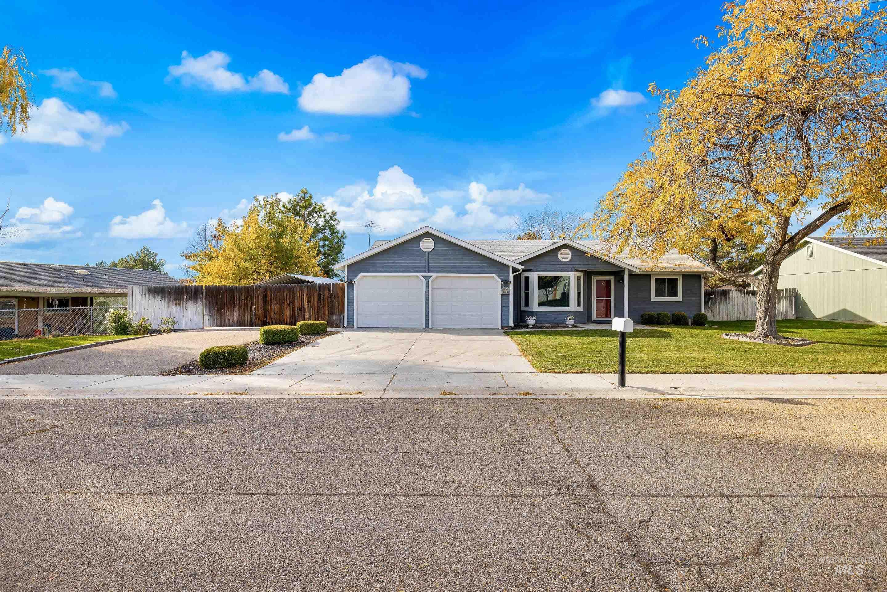 Ranch-style house with concrete driveway and a garage