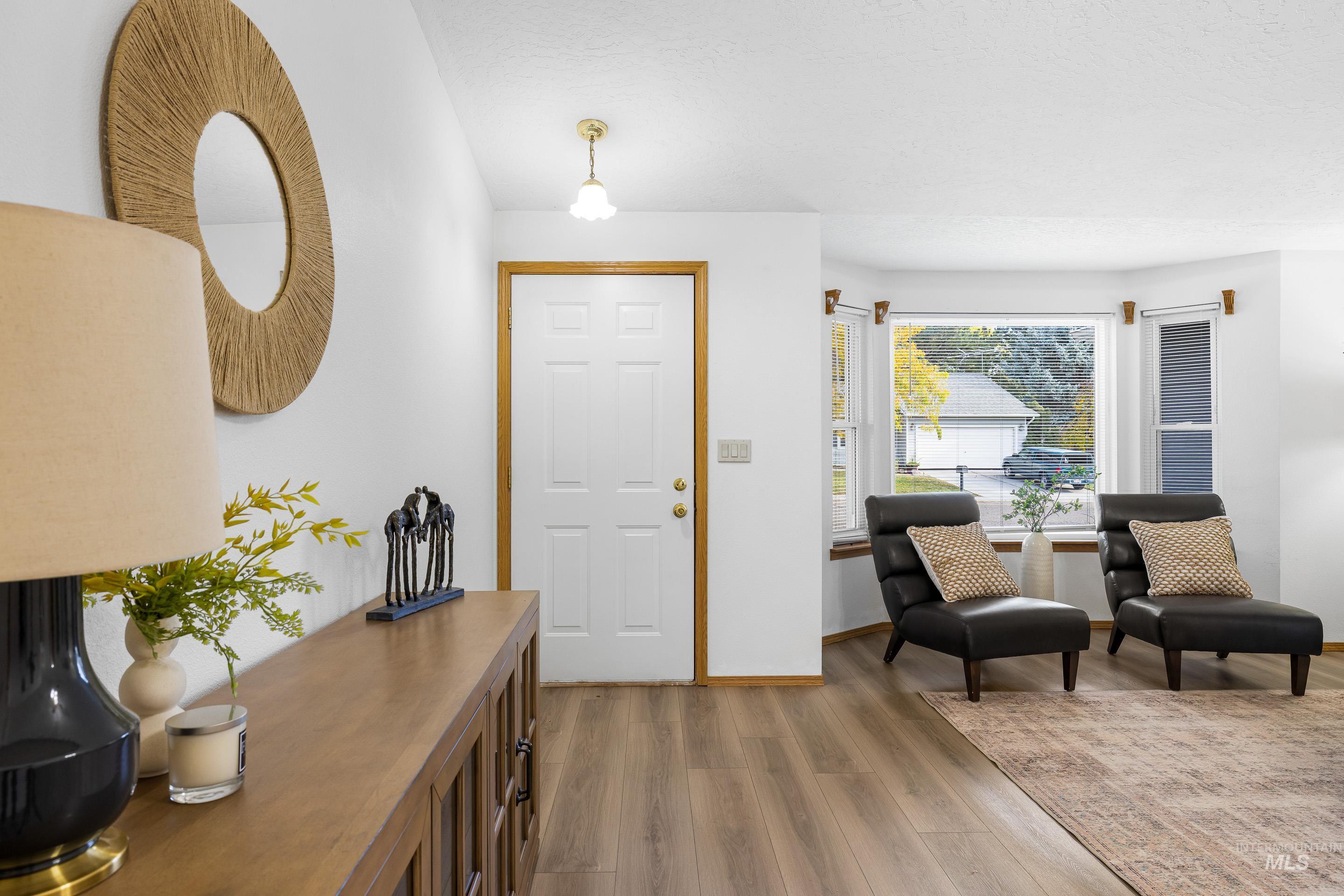 Entryway with light wood-style floors and baseboards