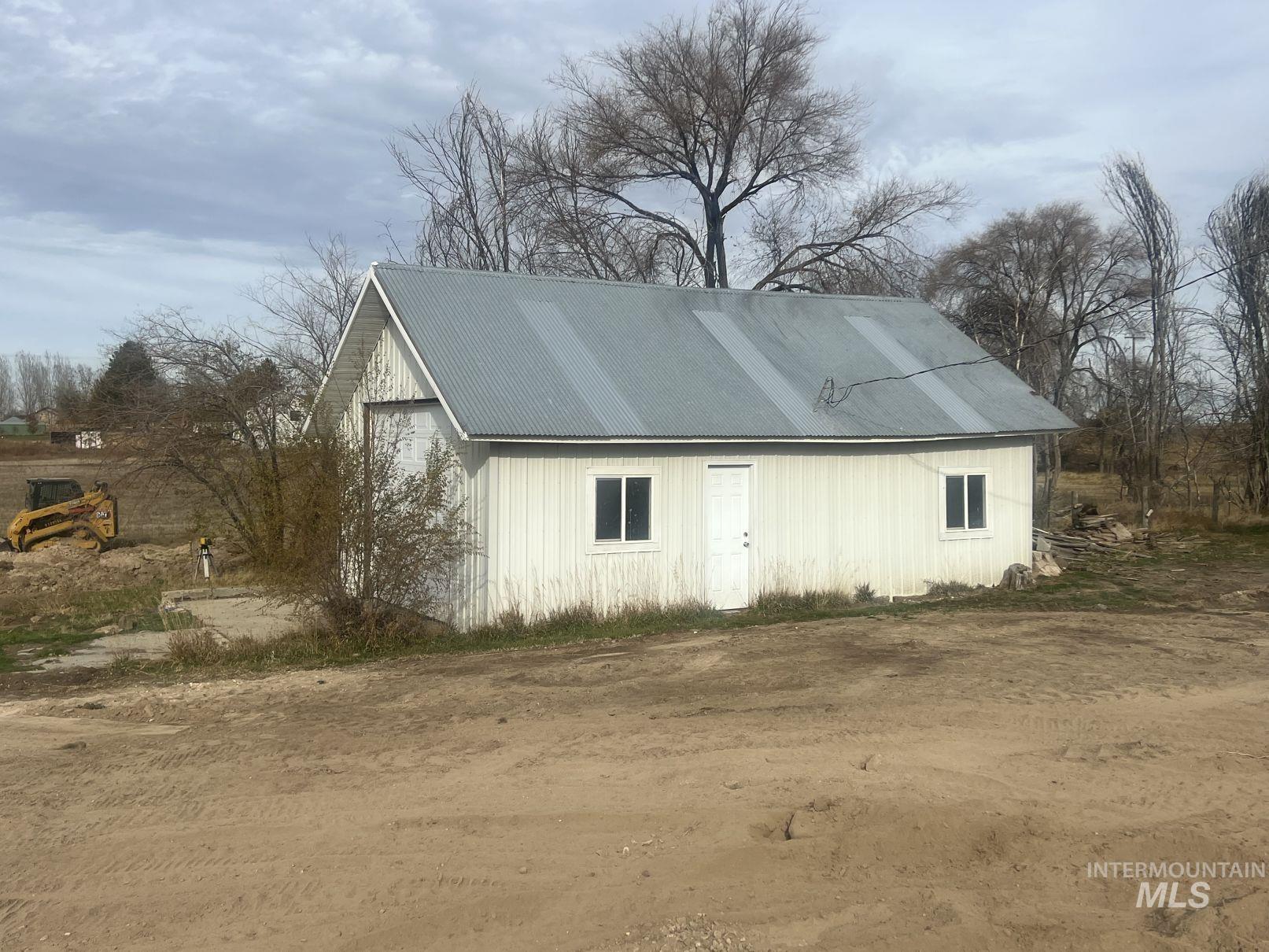 View of home's exterior with an outbuilding and a metal roof