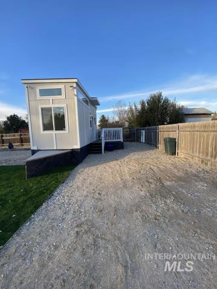 View of side of property with a deck and a fenced backyard