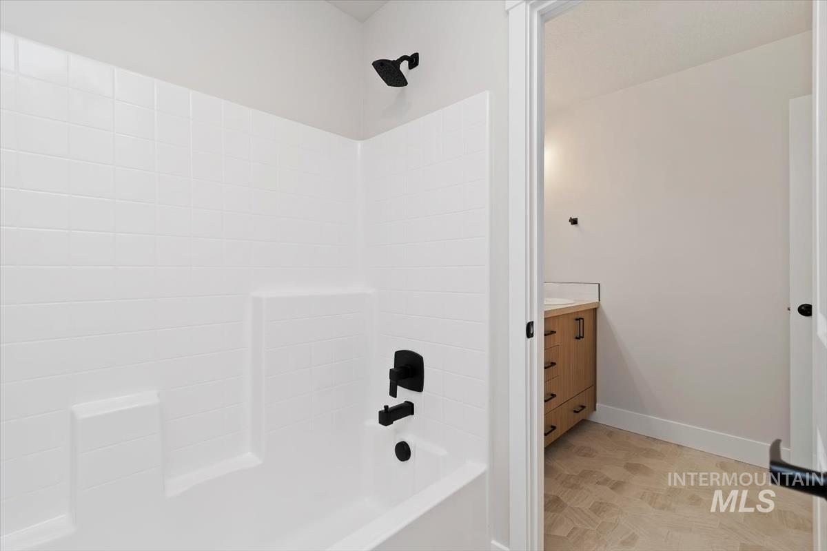 Full bath featuring vanity and bathtub / shower combination