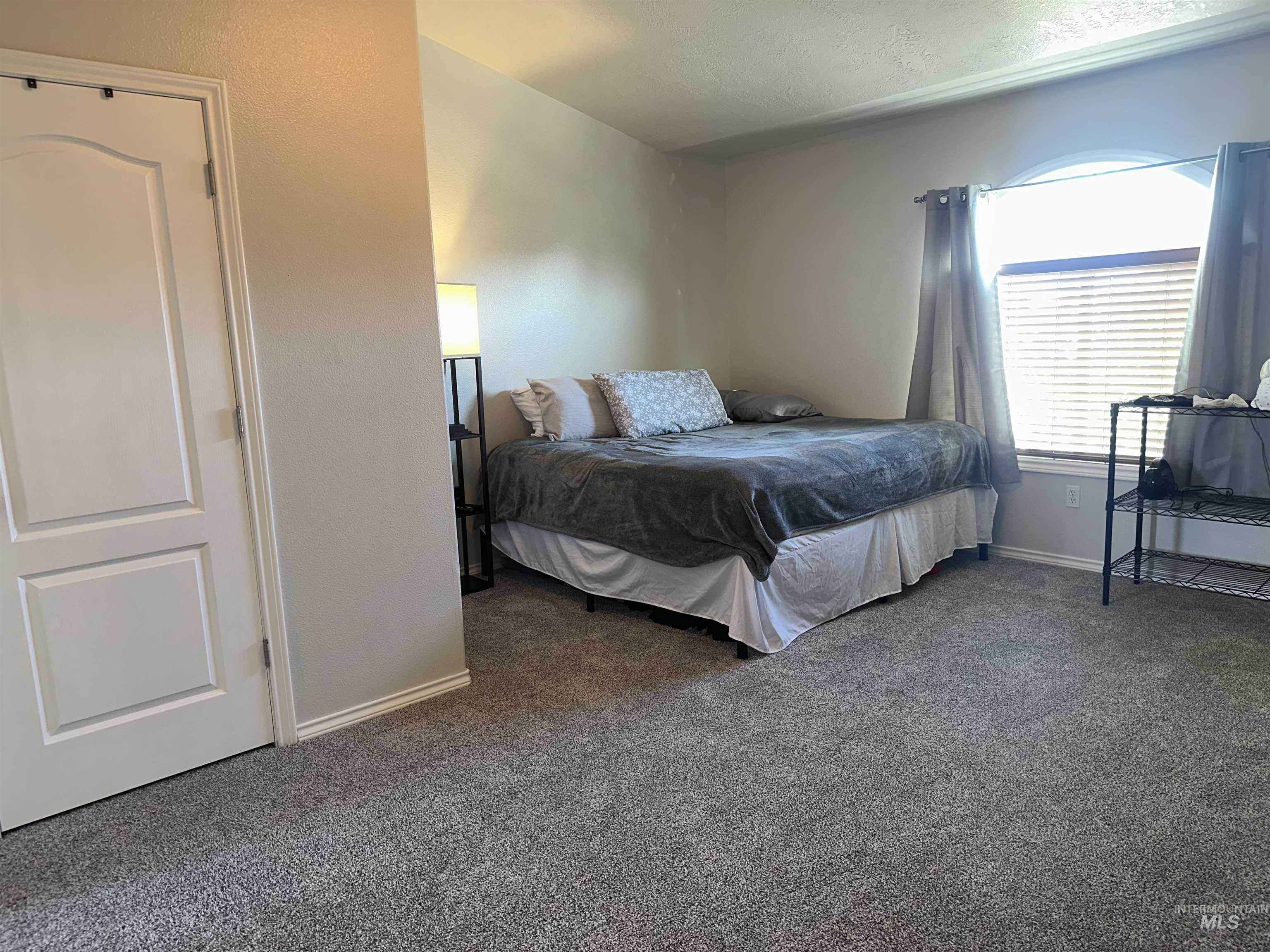 Bedroom with carpet and baseboards
