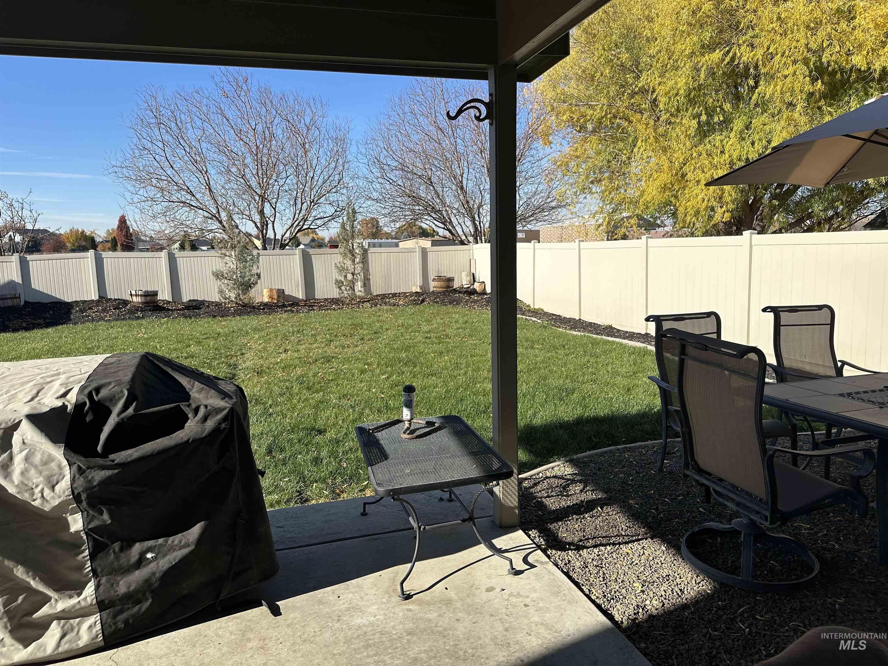 Fenced backyard with a patio